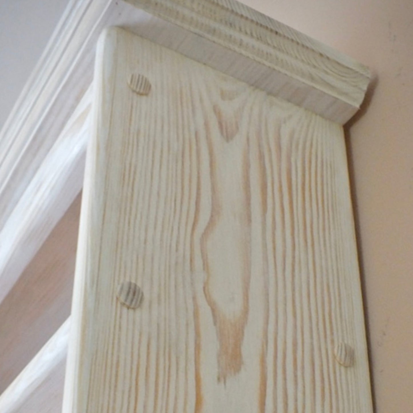 Close-up of a wooden beam with visible grain and texture.