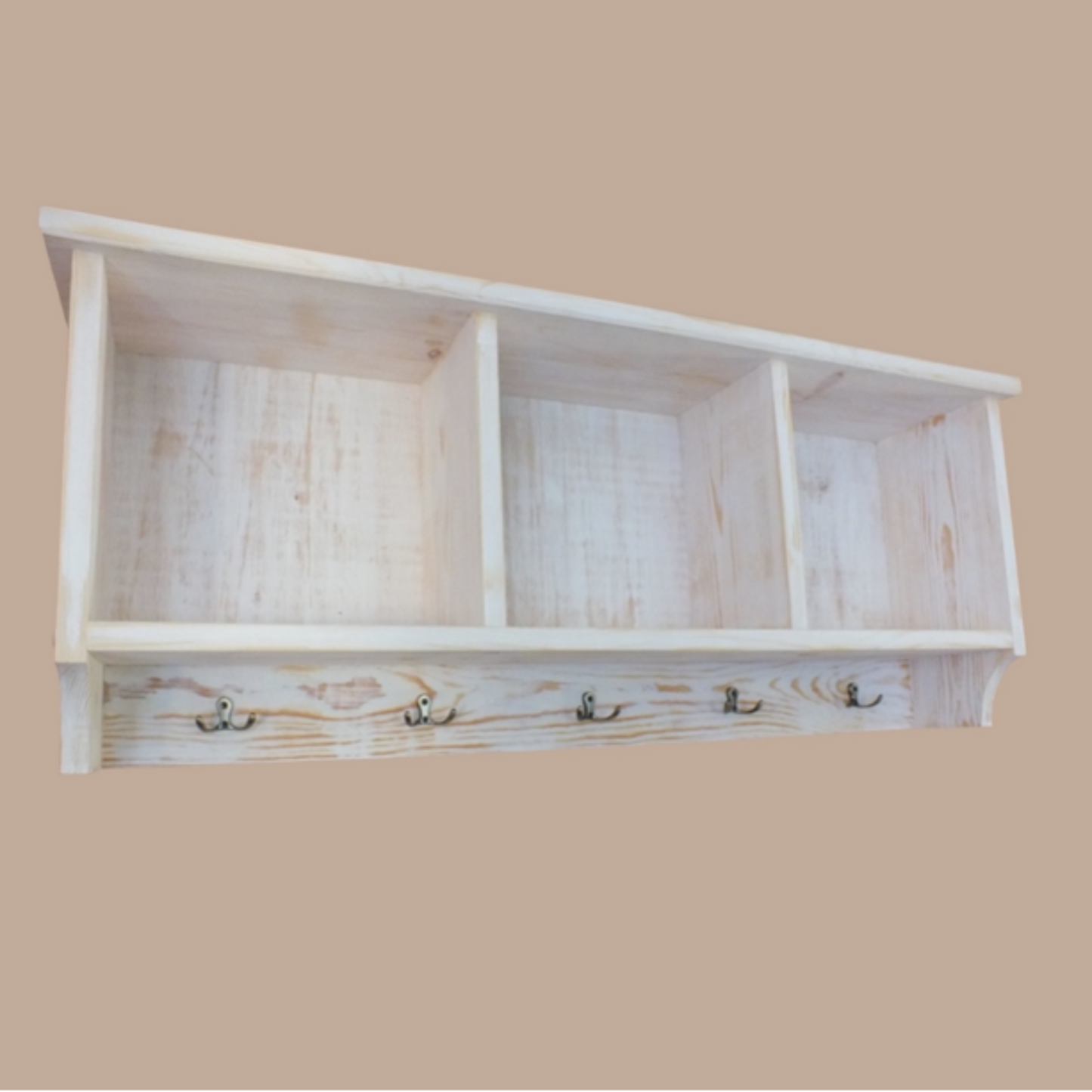 Wooden shelf with hooks on a beige background