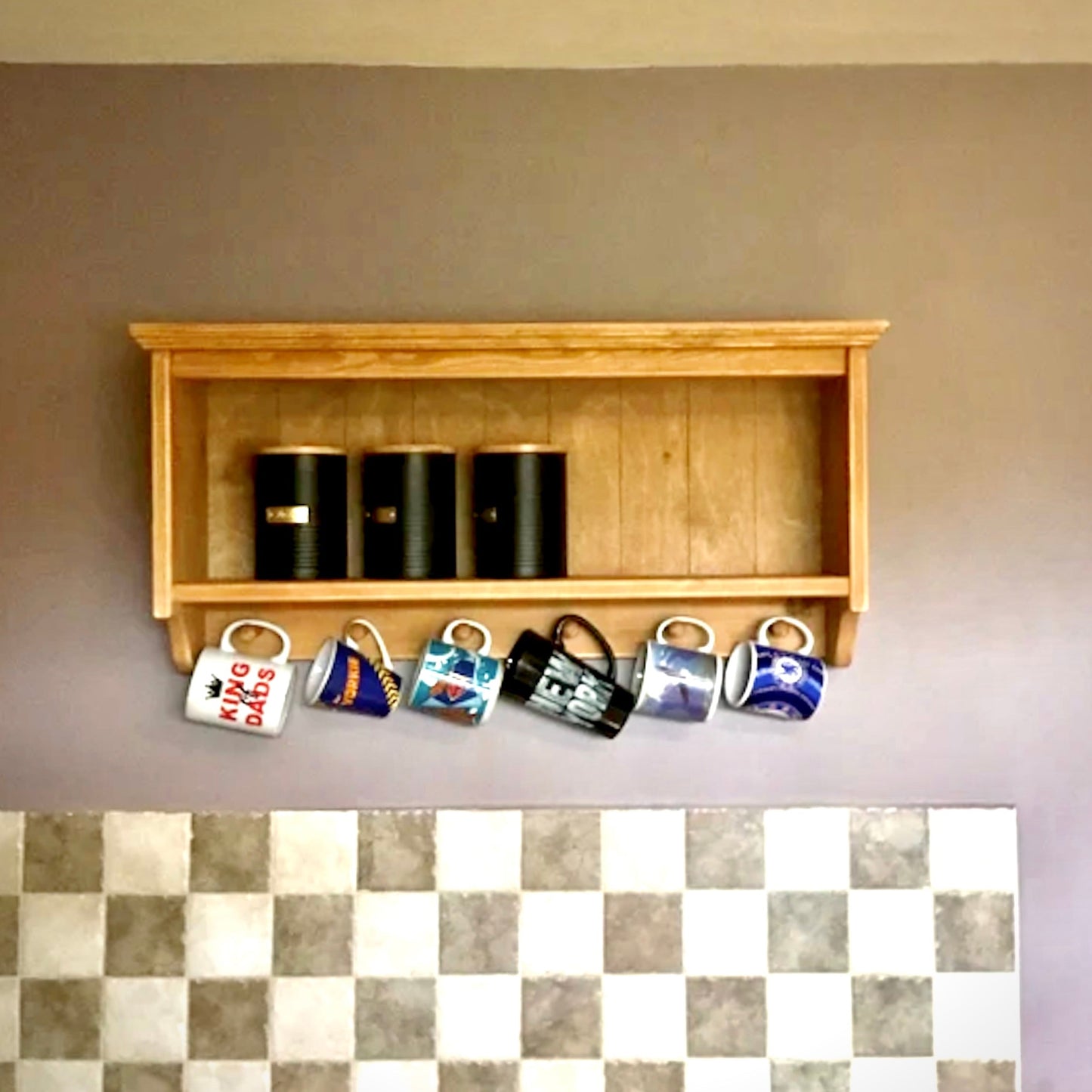 Wooden shelf with coffee cups and a checkered floor
