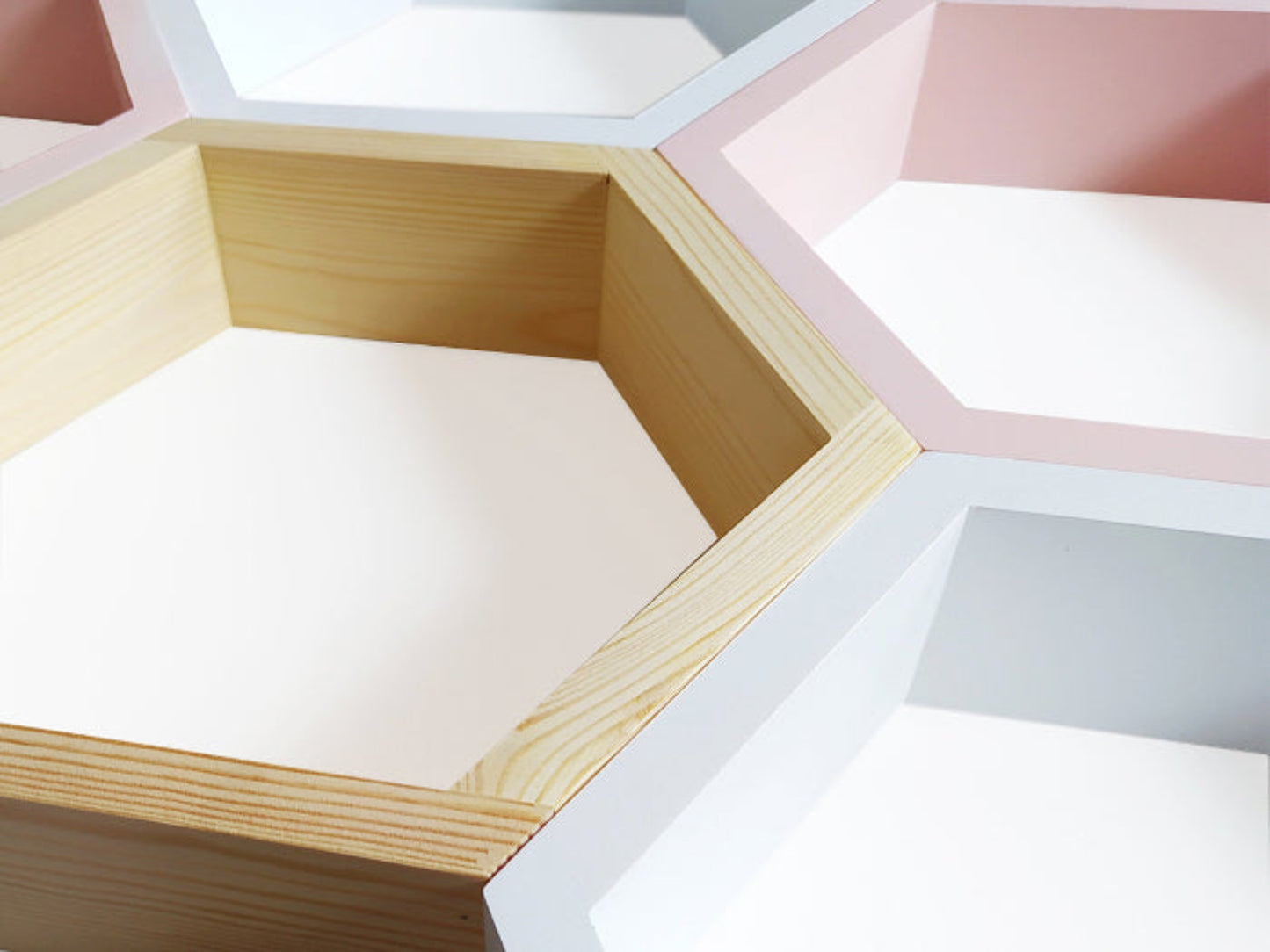 Hexagonal wooden shelves in a geometric arrangement with pastel colors.