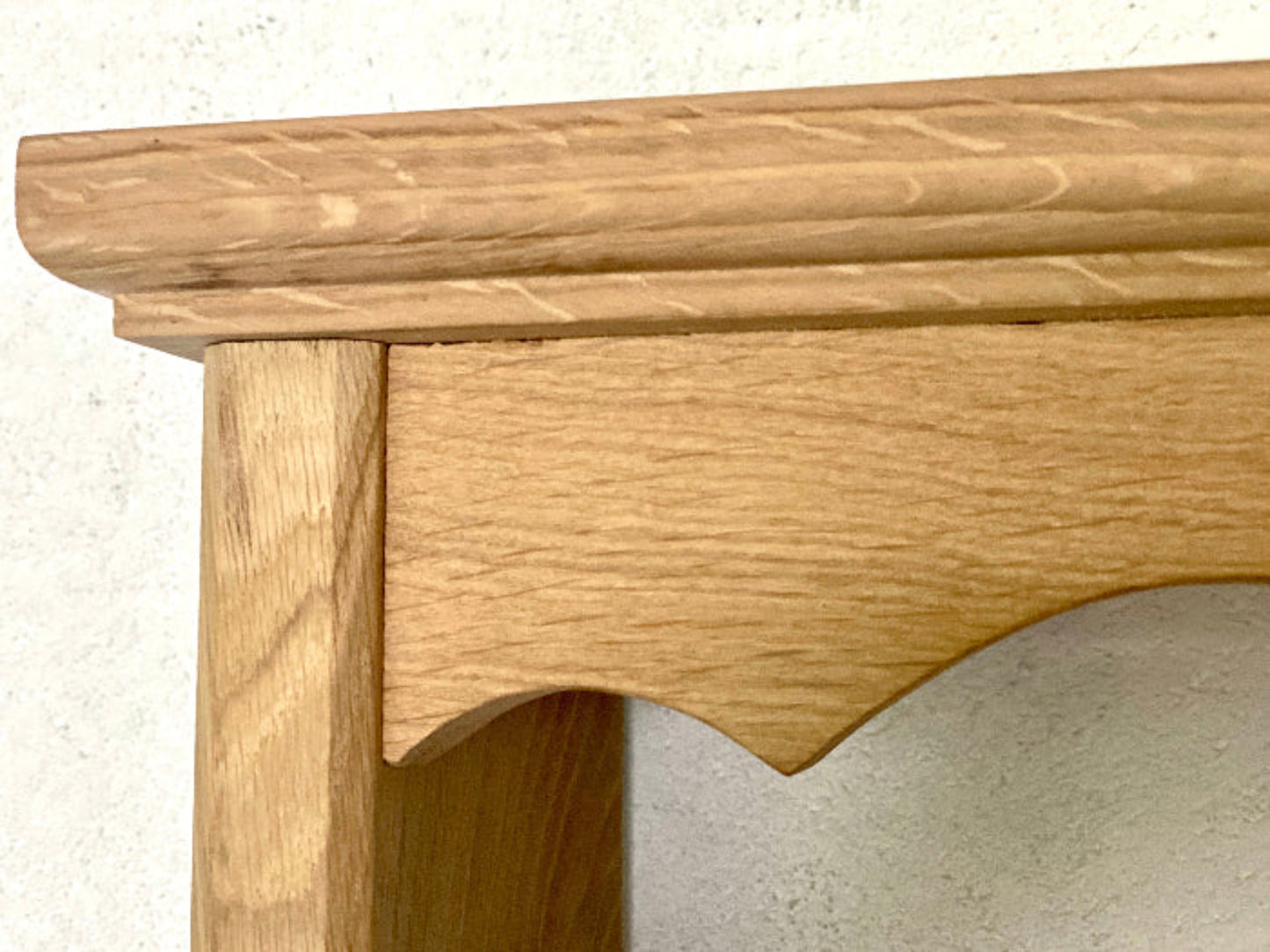Close-up of a wooden mirror frame on a light background