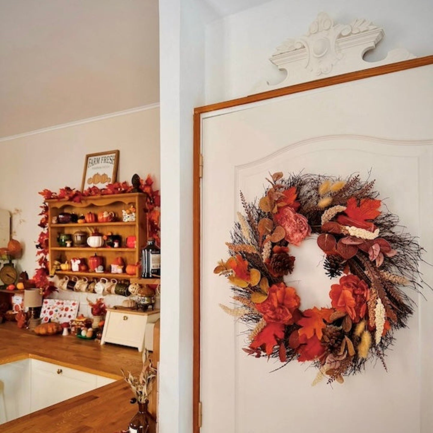 Decorative wreath on a door with a cozy room in the background