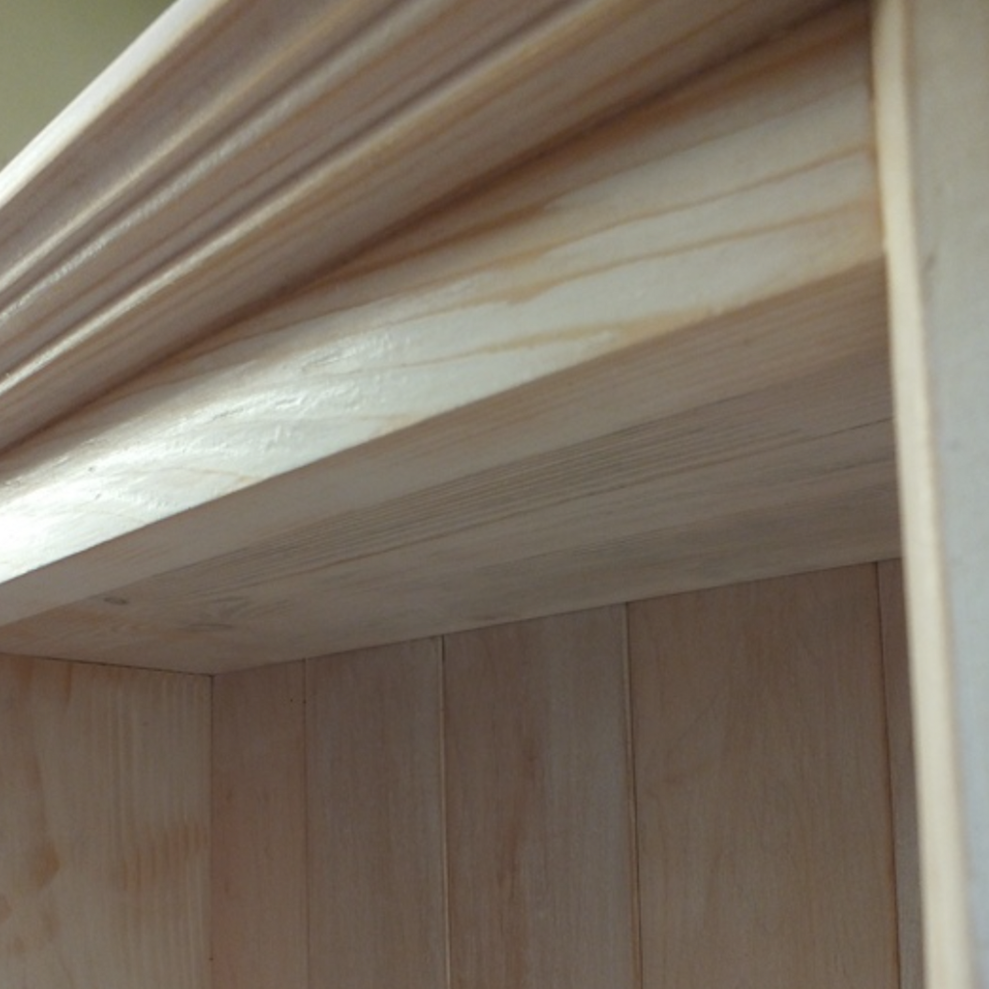 Close-up of a wooden shelf with a focus on the texture and grain.