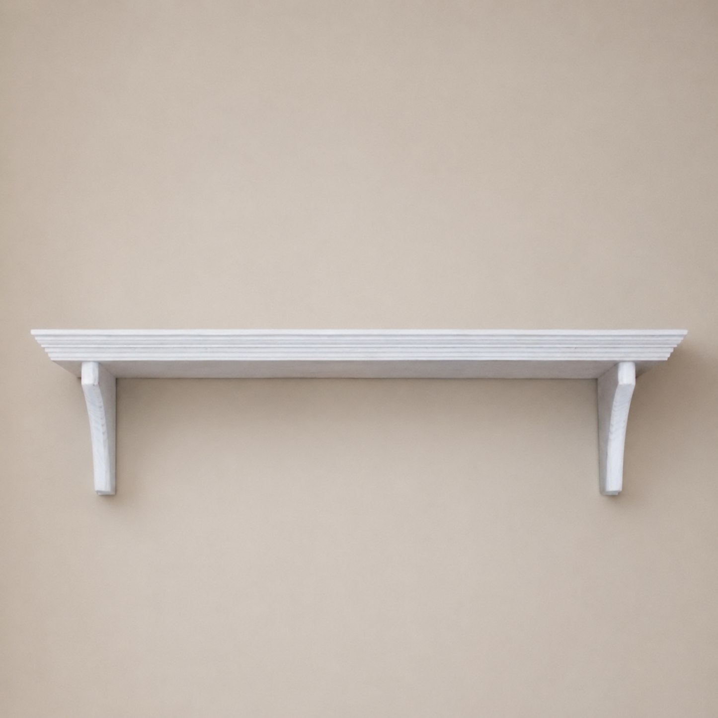 White shelf mounted on a beige wall