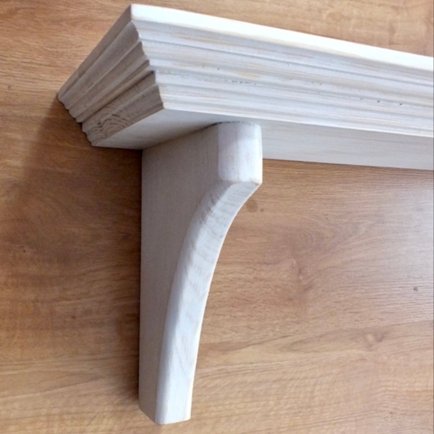 Wooden shelf bracket on a wooden surface