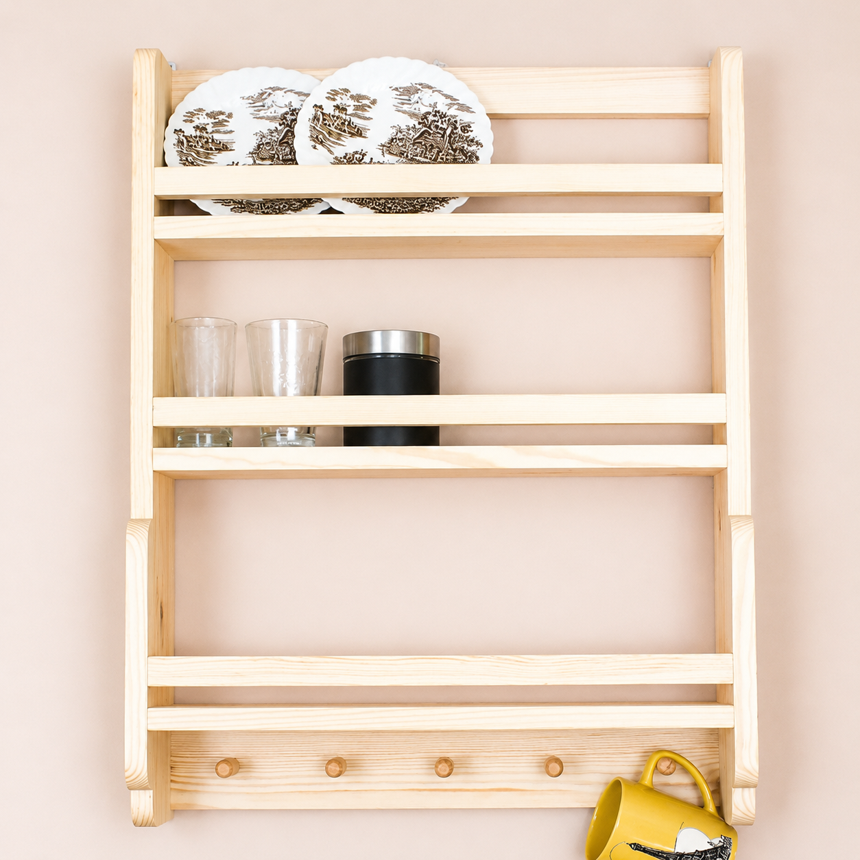 Wooden wall shelf with decorative items against a beige wall