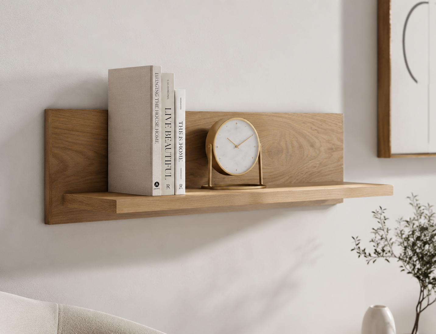 Wooden shelf with books and a clock on a white wall