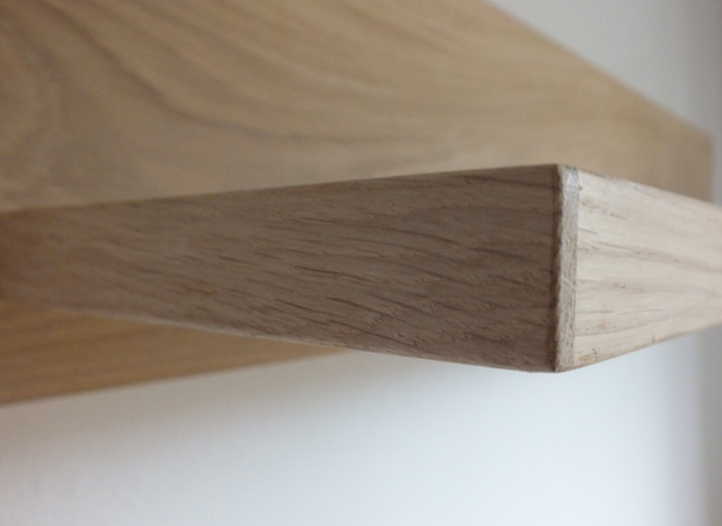Close-up of a wooden shelf corner on a white background