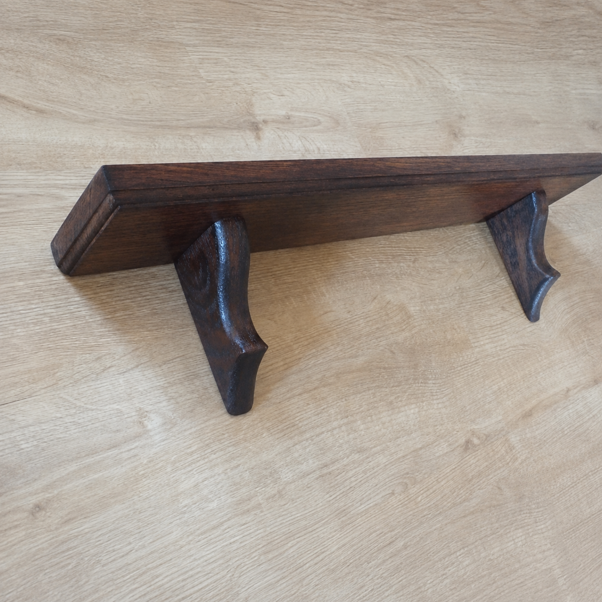 Wooden shelf bracket on a wooden surface