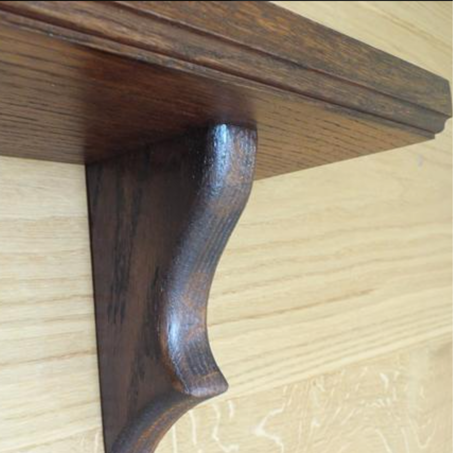 Wooden shelf bracket on a wooden surface