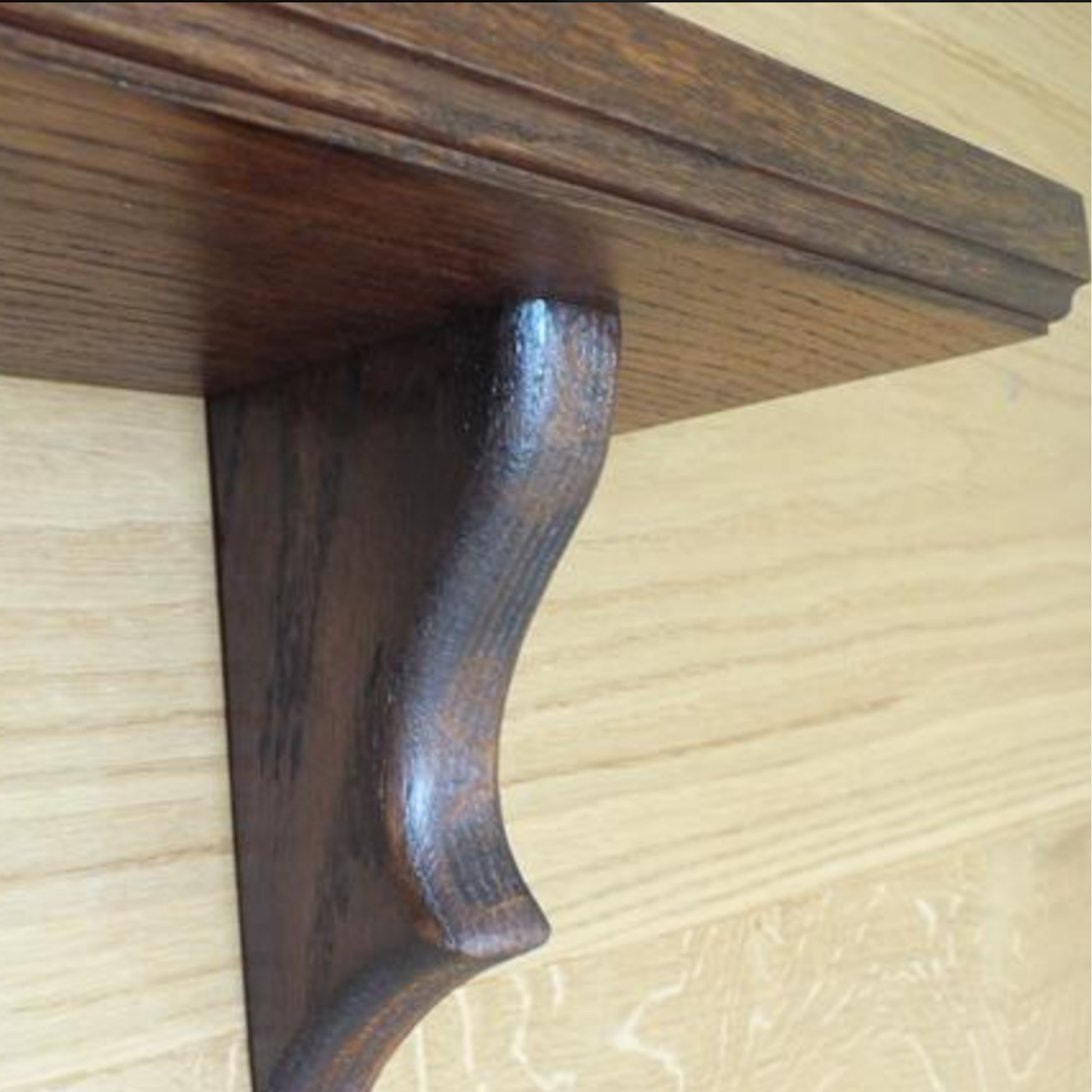 Wooden shelf bracket on a wooden surface