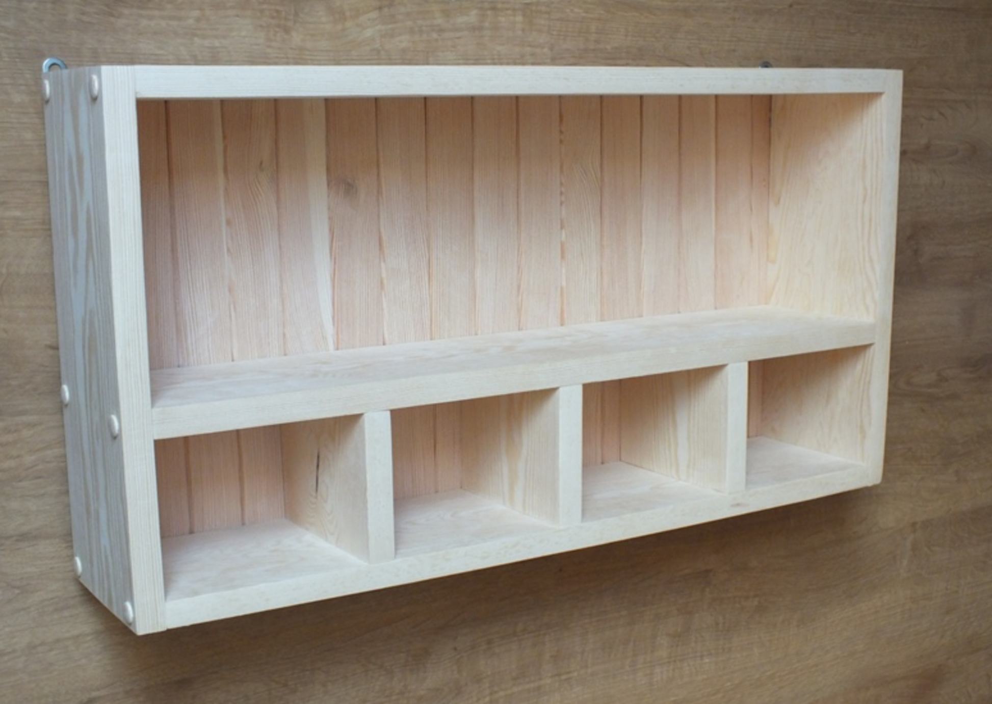 Wooden shelf with multiple compartments on a wooden background