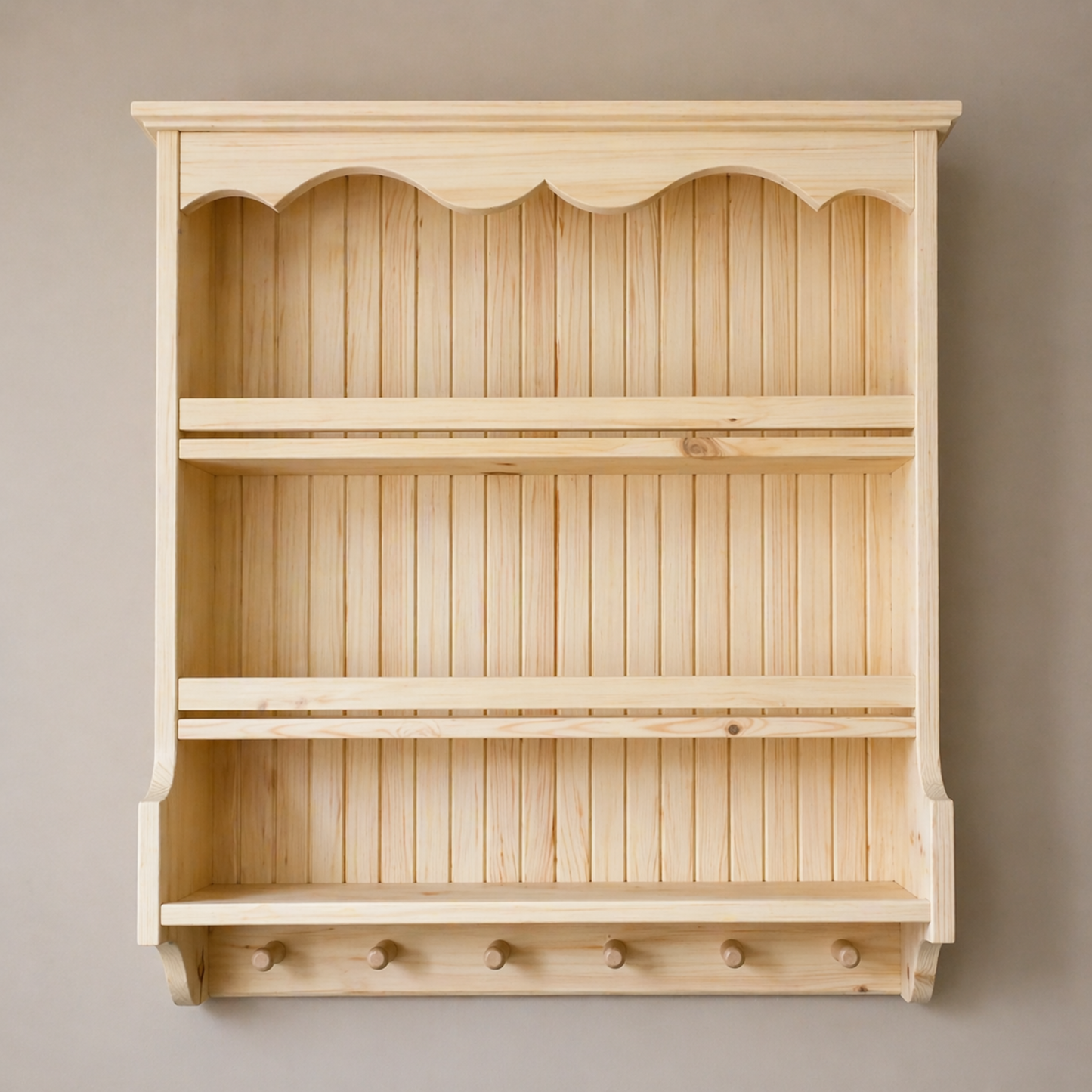 Wooden wall shelf with decorative top and bottom on a plain background