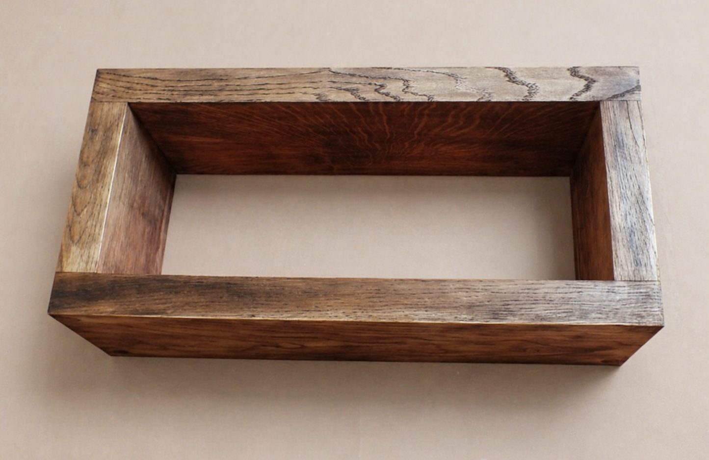 Wooden box with a rustic finish on a beige background