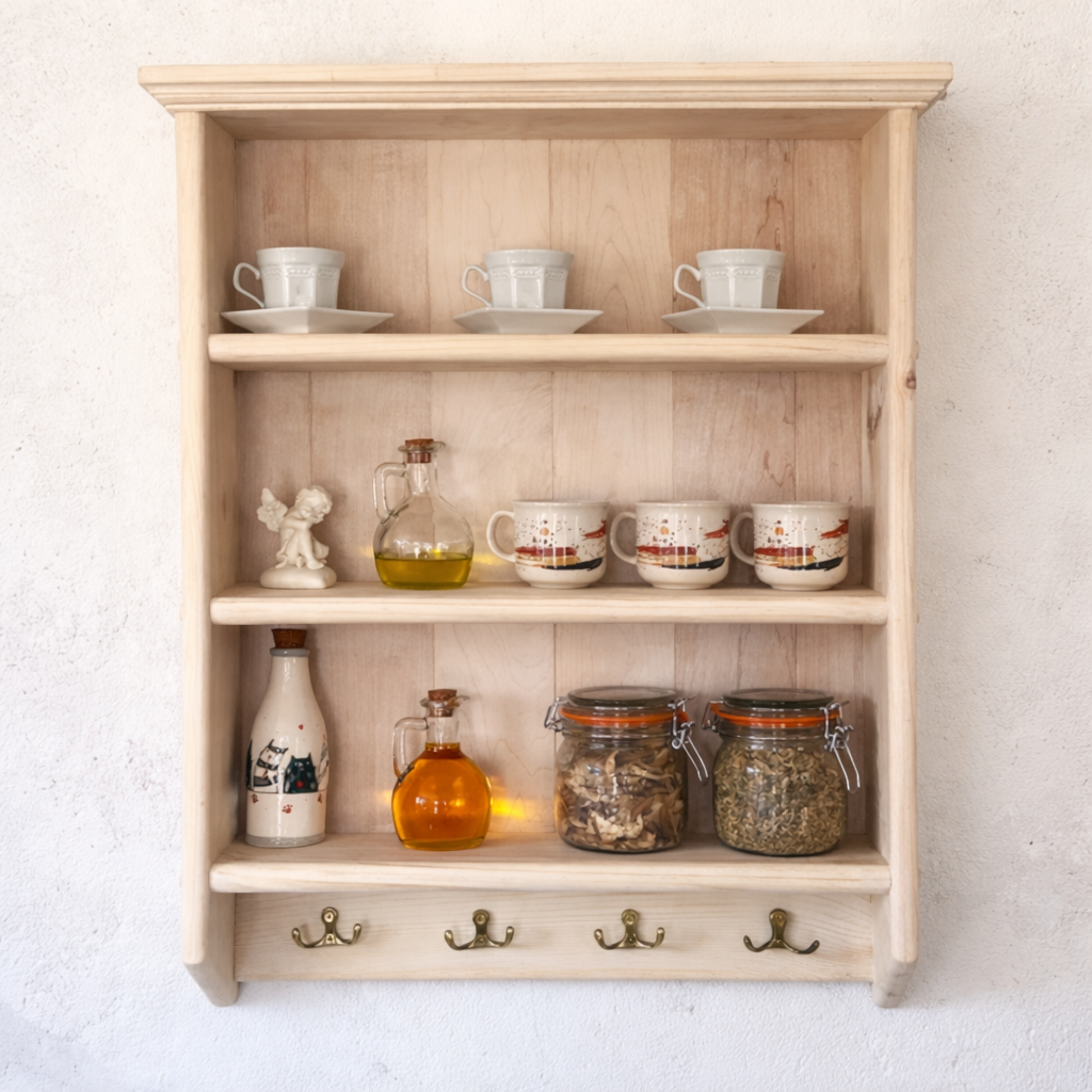 Wooden shelf with various items including cups, jars, and bottles against a white wall.