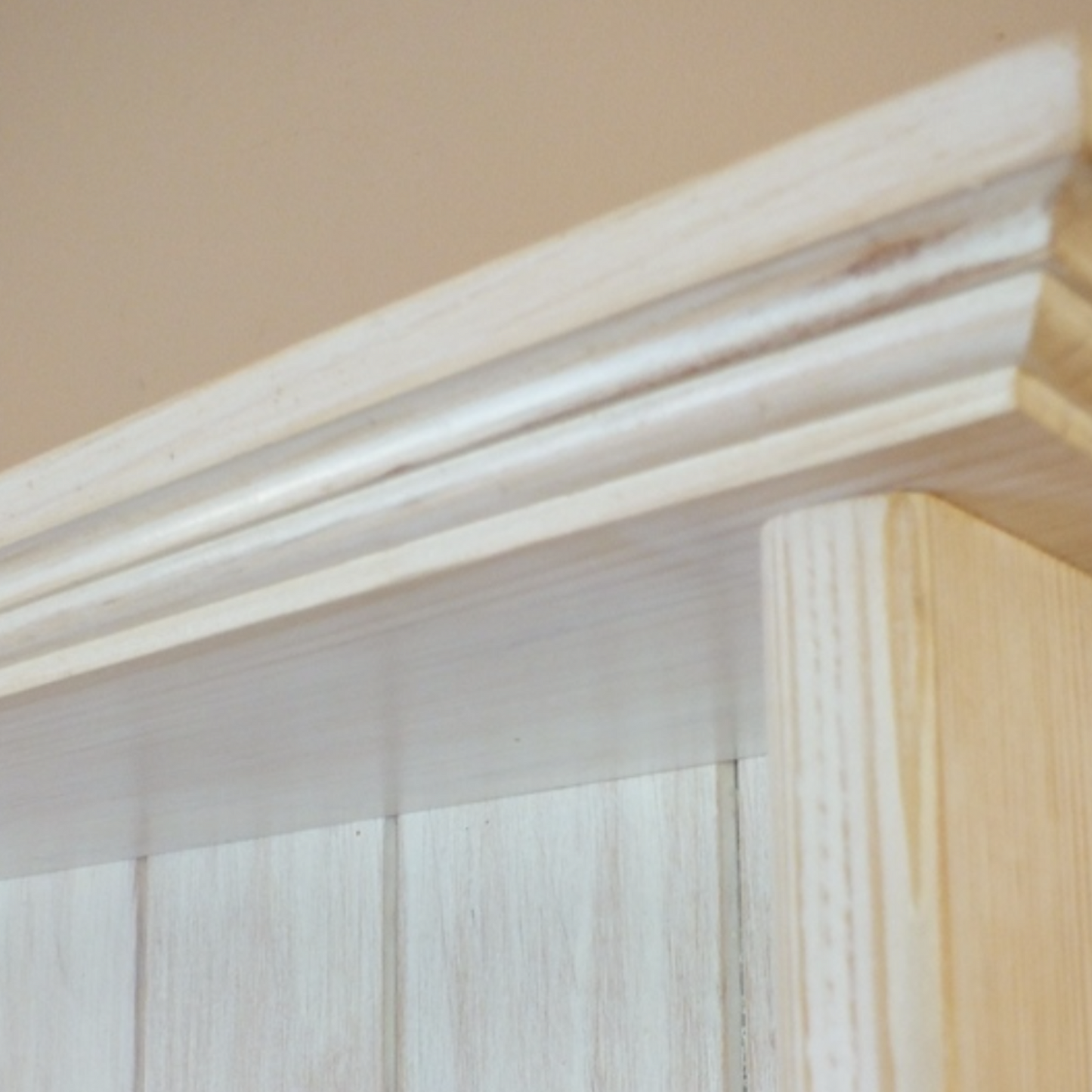 Close-up of a window blind with wooden frame and beige wall background