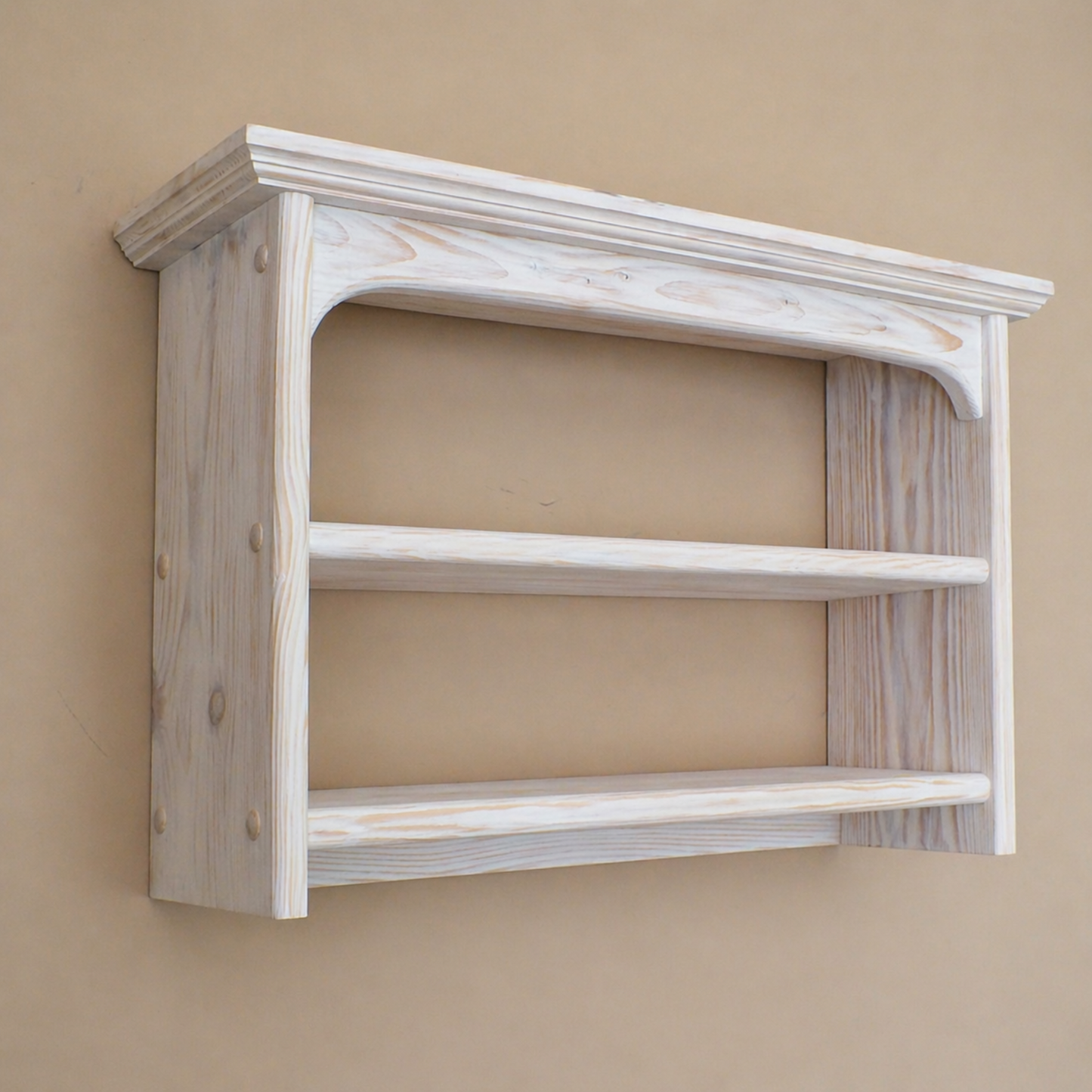 Wooden wall shelf with a rustic finish on a beige wall