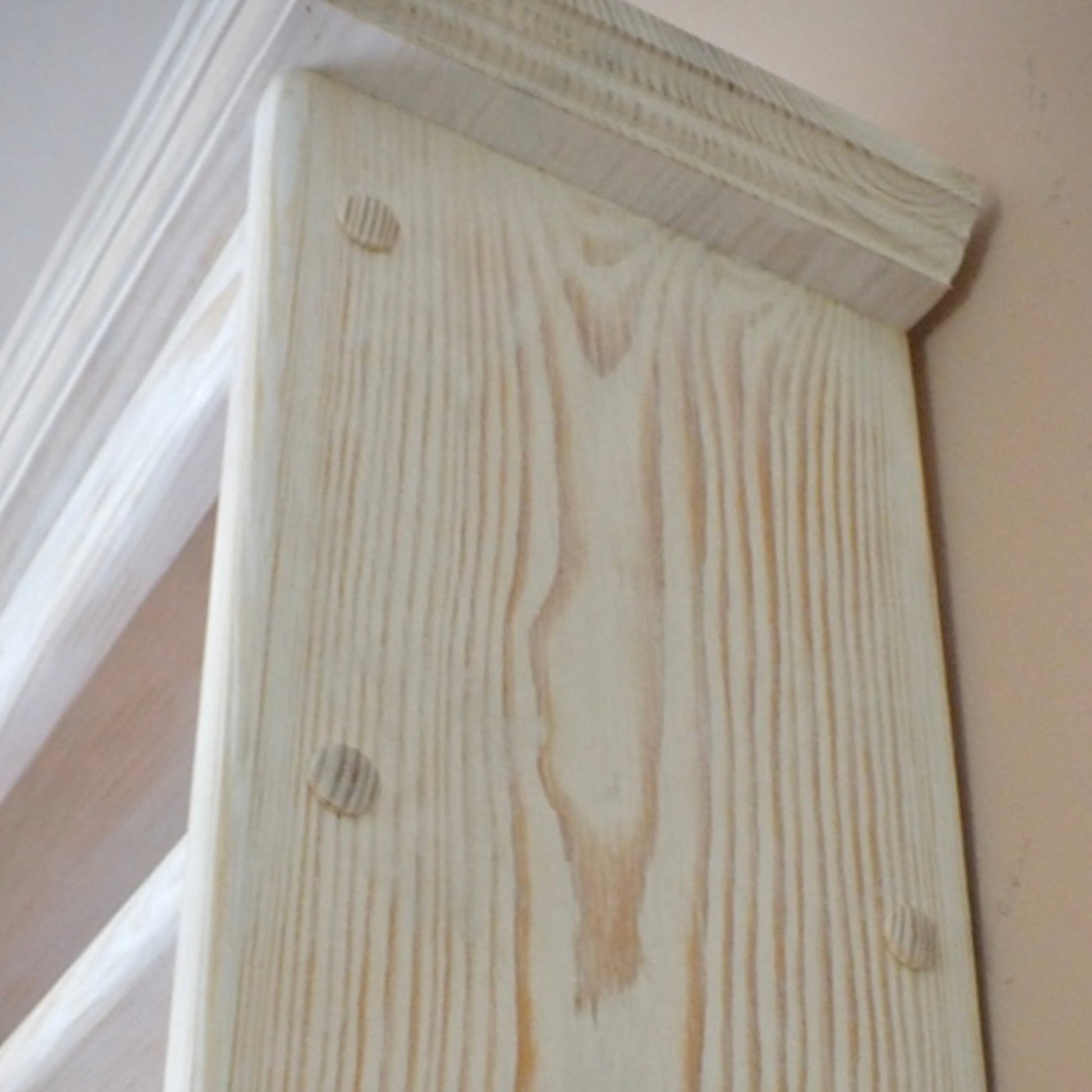 Close-up of a wooden beam with visible grain and texture.