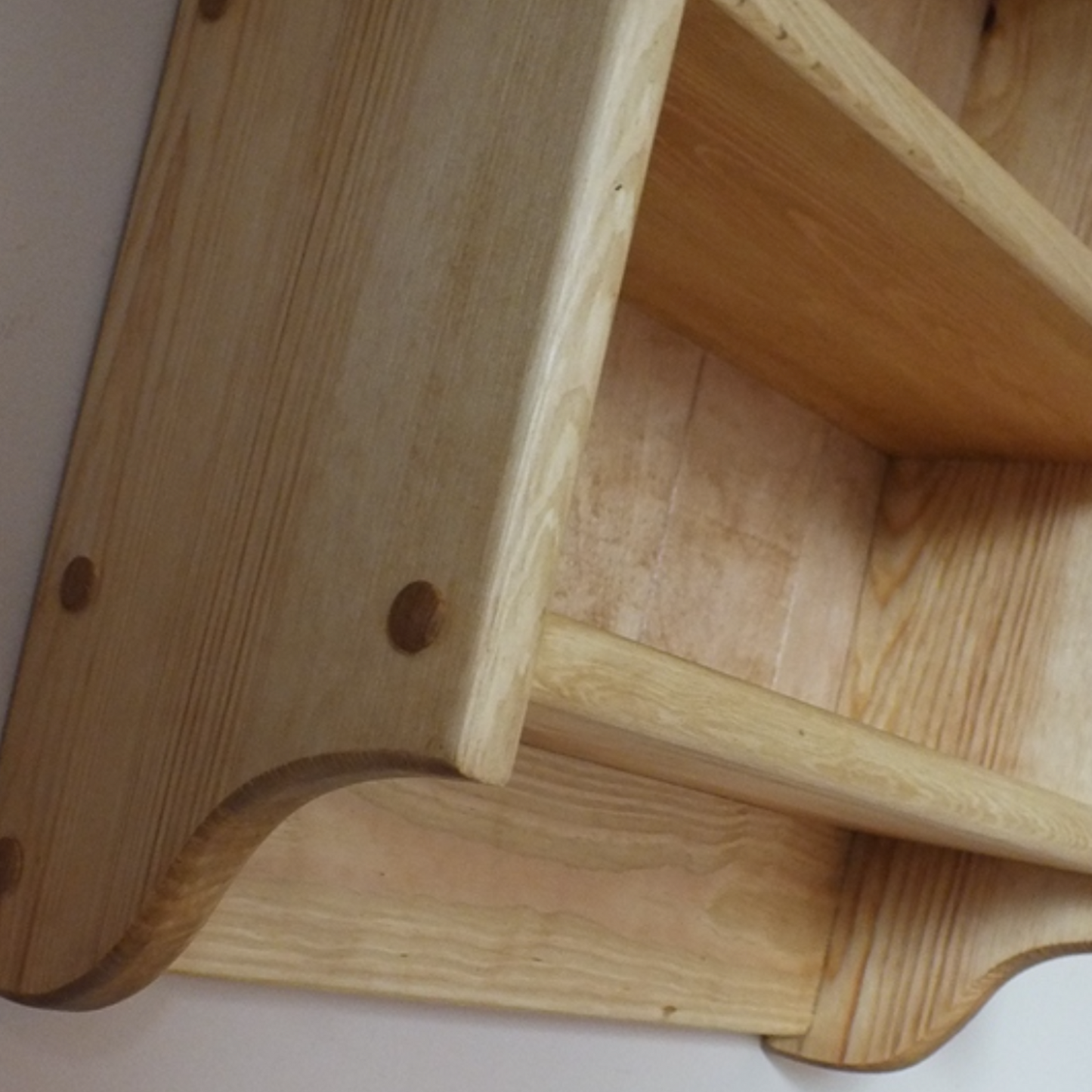 Wooden shelf corner on a white background