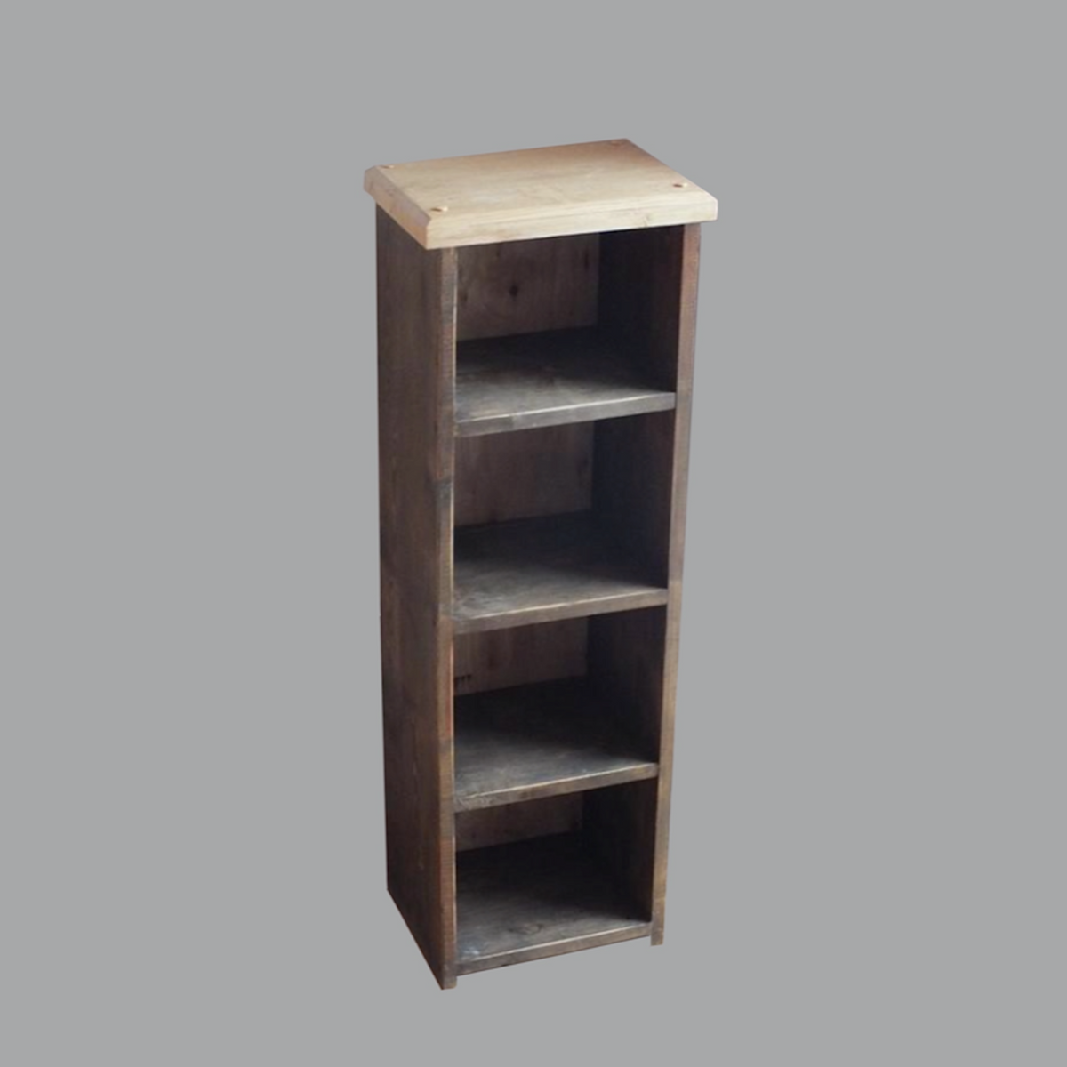 A tall, narrow wooden bookcase with four open shelves, featuring a light natural wood top and darker brown wood shelves, shown against a solid gray background.