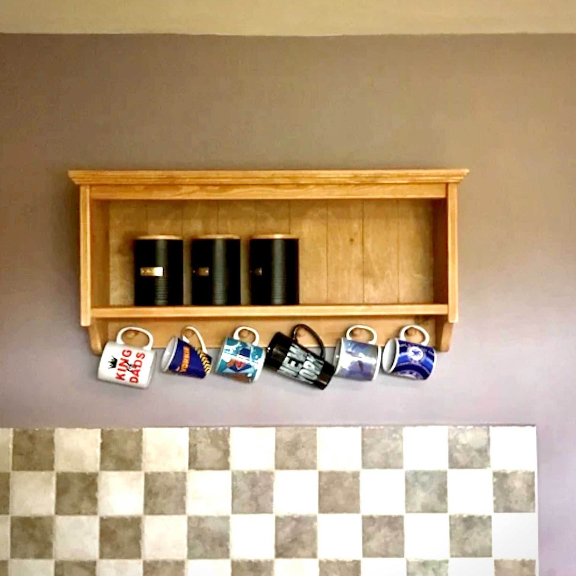 Wooden shelf with coffee cups and a checkered floor