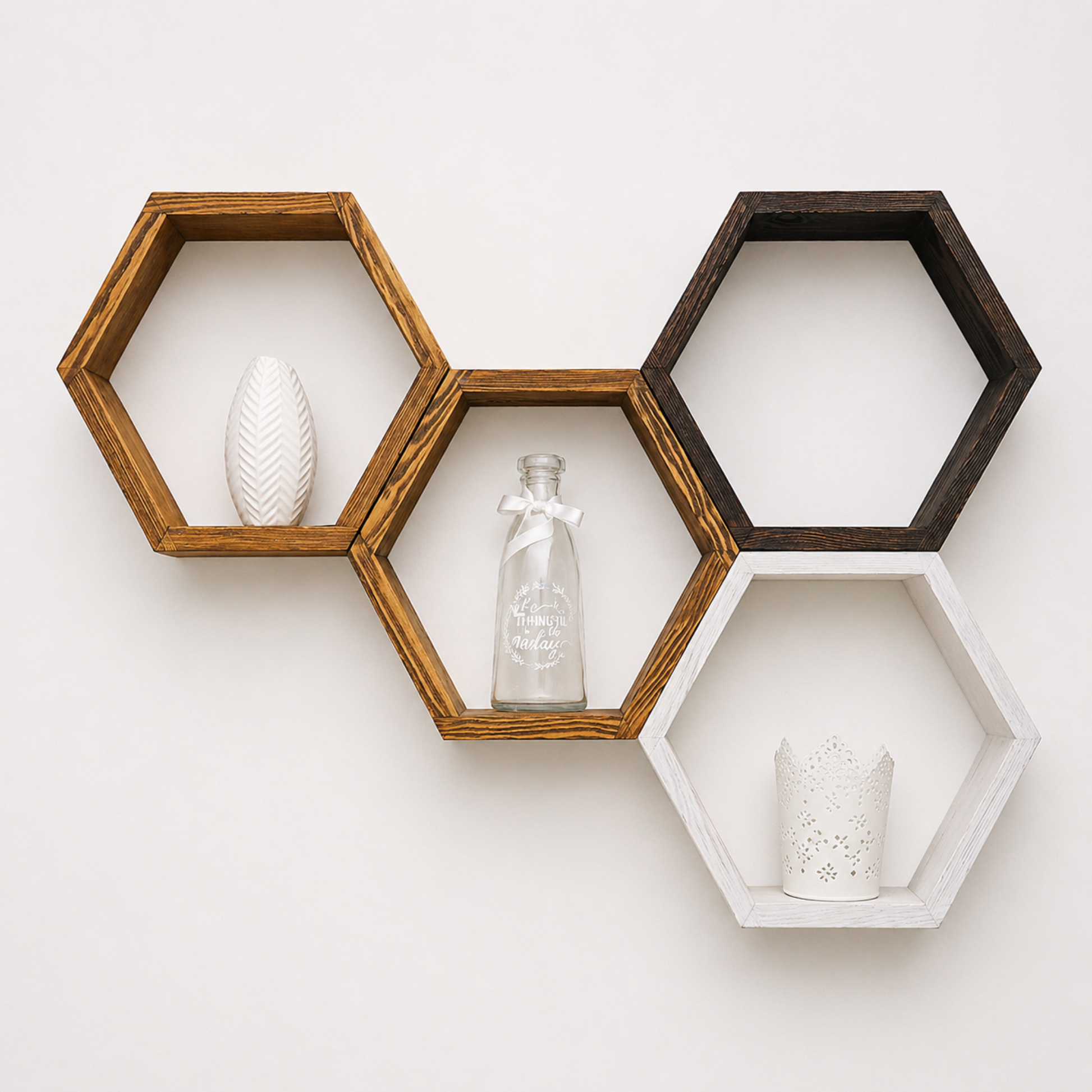 Hexagonal wooden shelves with decorative items on a white wall