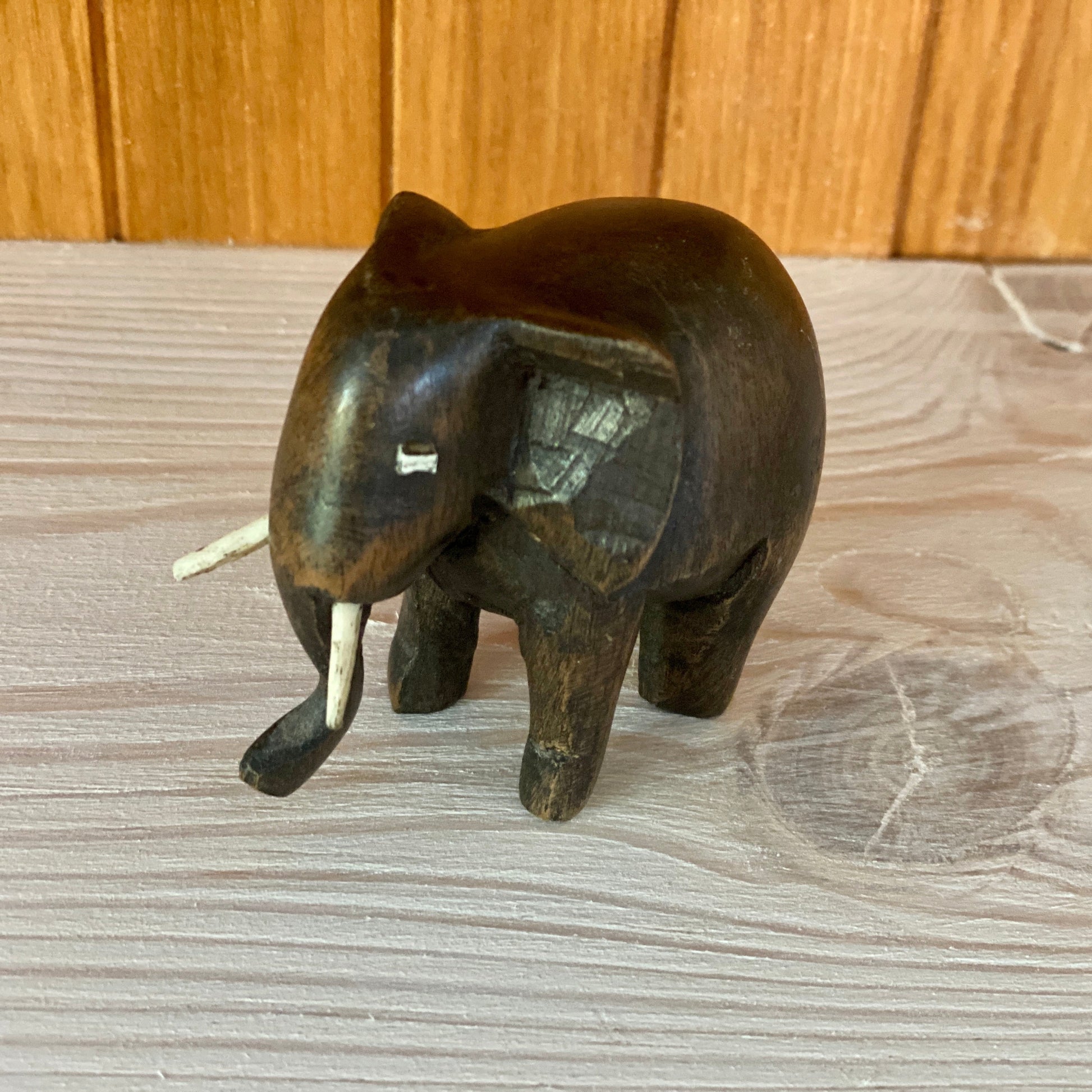Bronze elephant figurine on a wooden surface