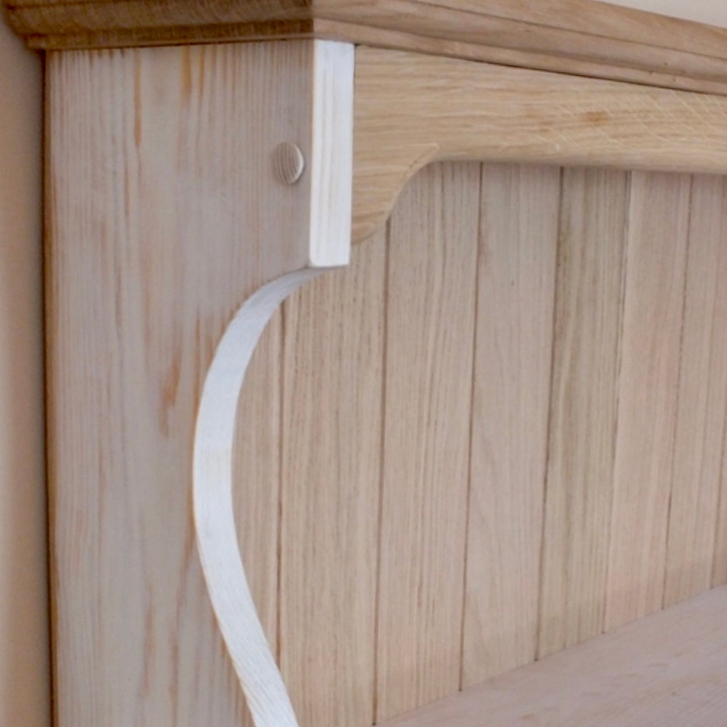 Wooden shelf bracket on a wooden surface
