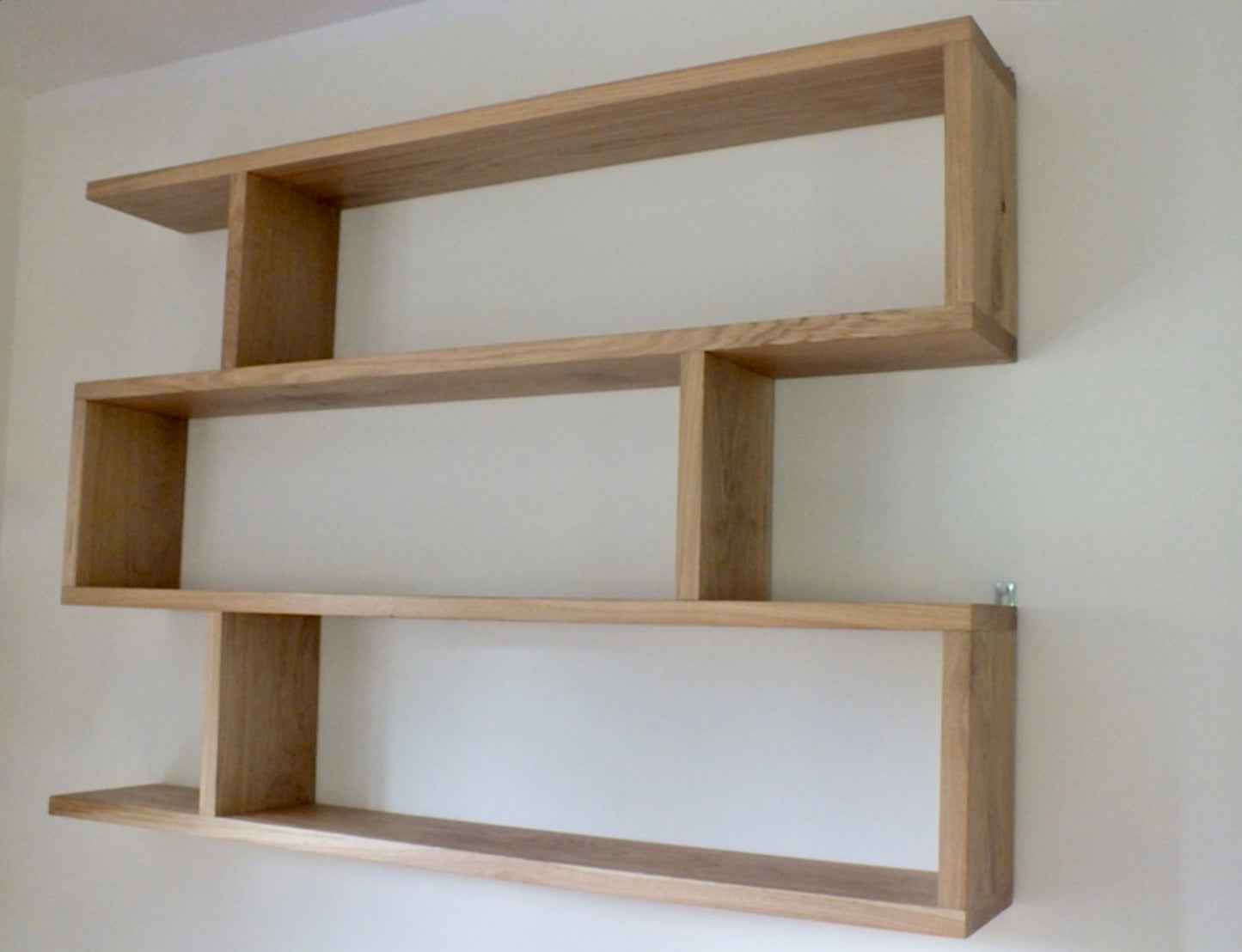 Wooden shelf against a plain wall