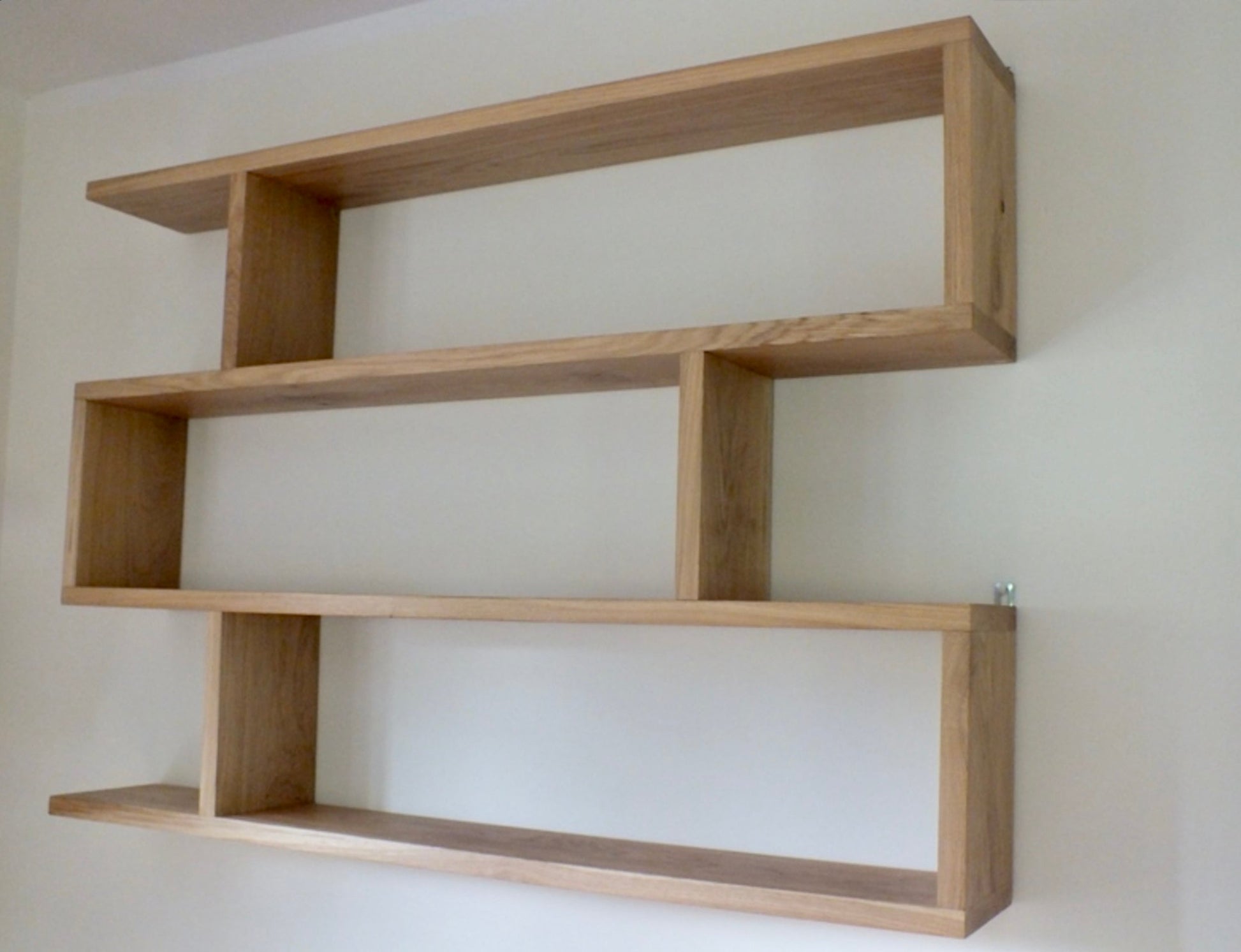 Wooden shelf against a plain wall