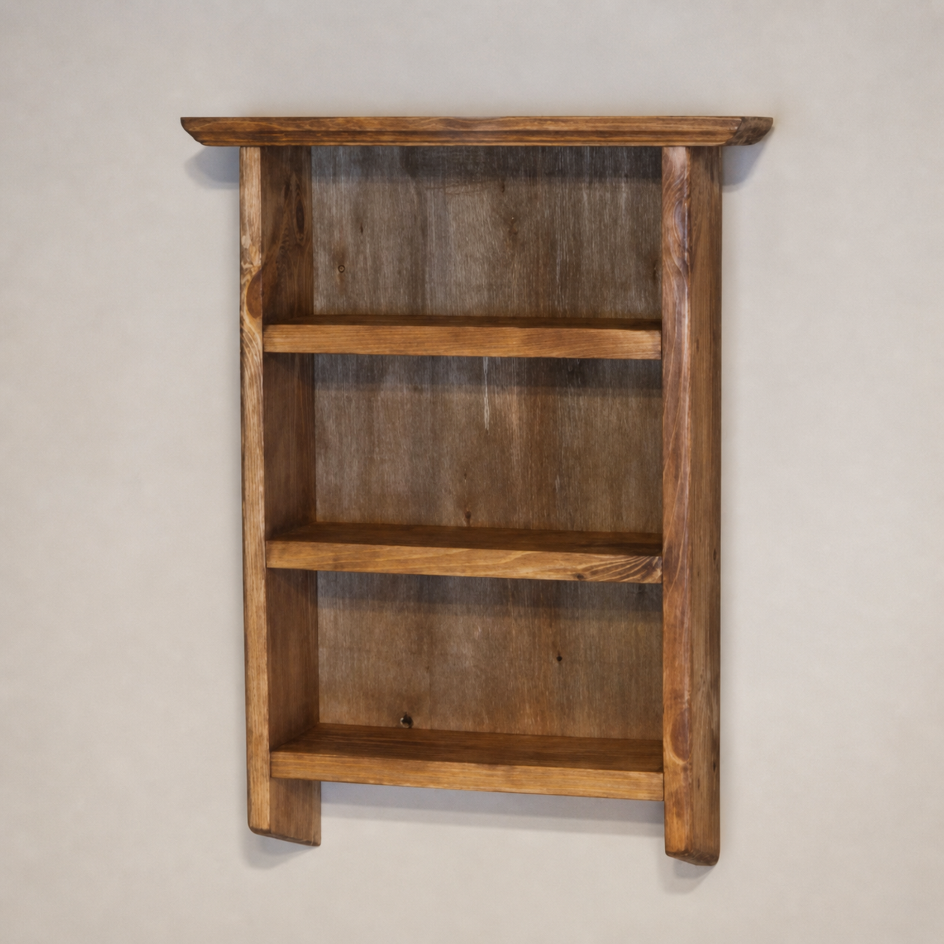 Wooden wall shelf with three shelves on a plain background