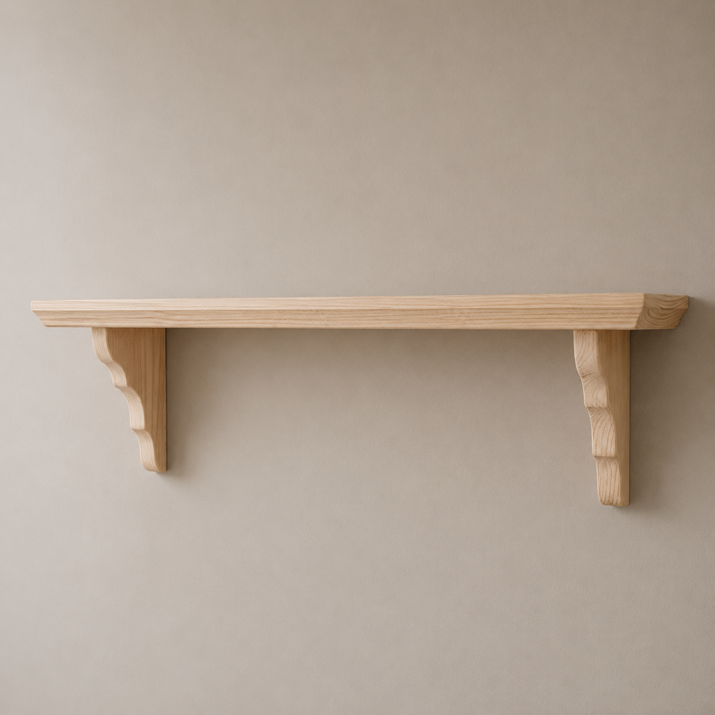 Wooden shelf with decorative brackets on a plain wall