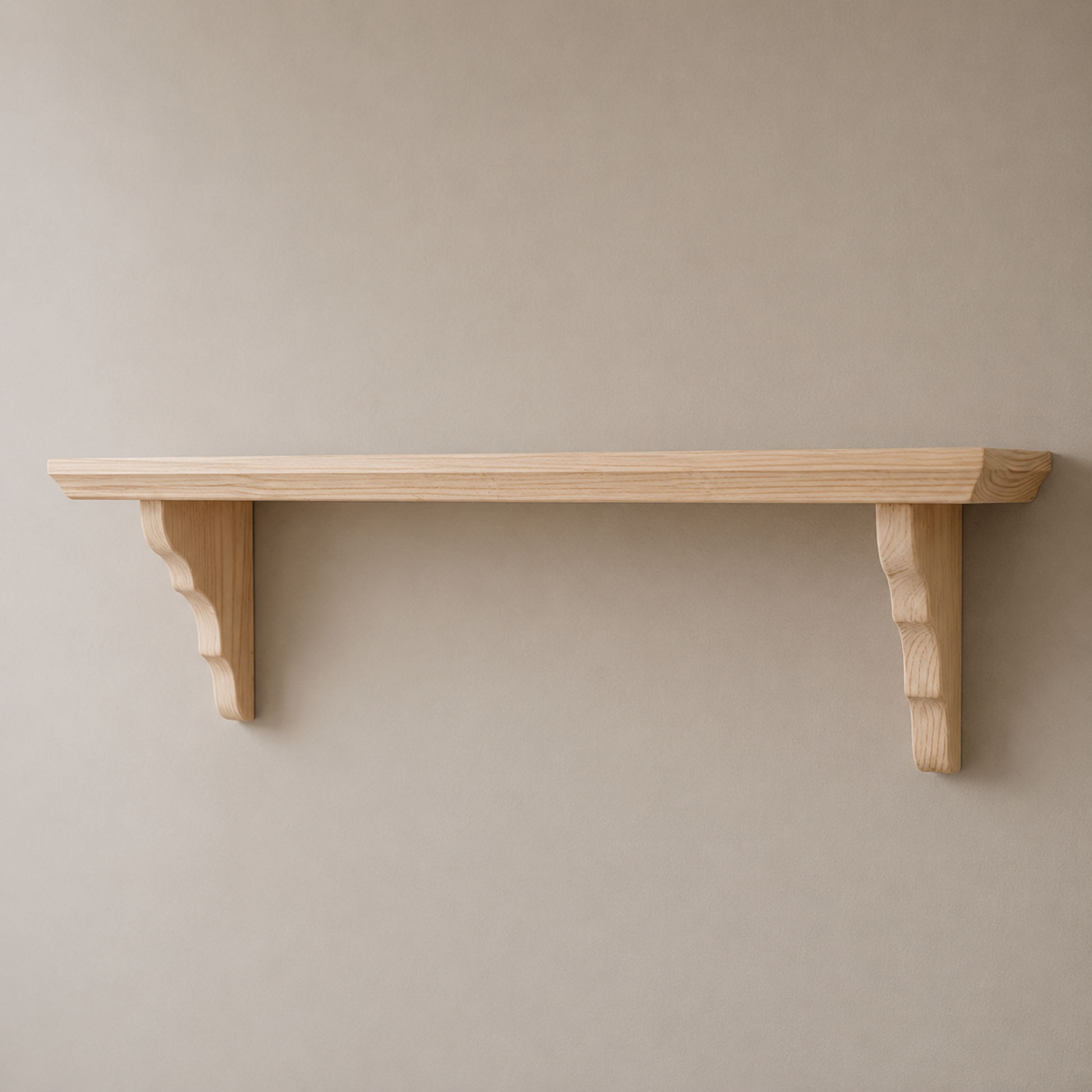 Wooden shelf with decorative brackets on a plain wall