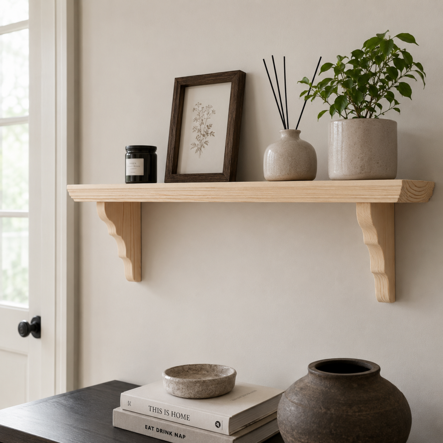 Wooden shelf with decorative items including a plant, books, and vases against a neutral wall.