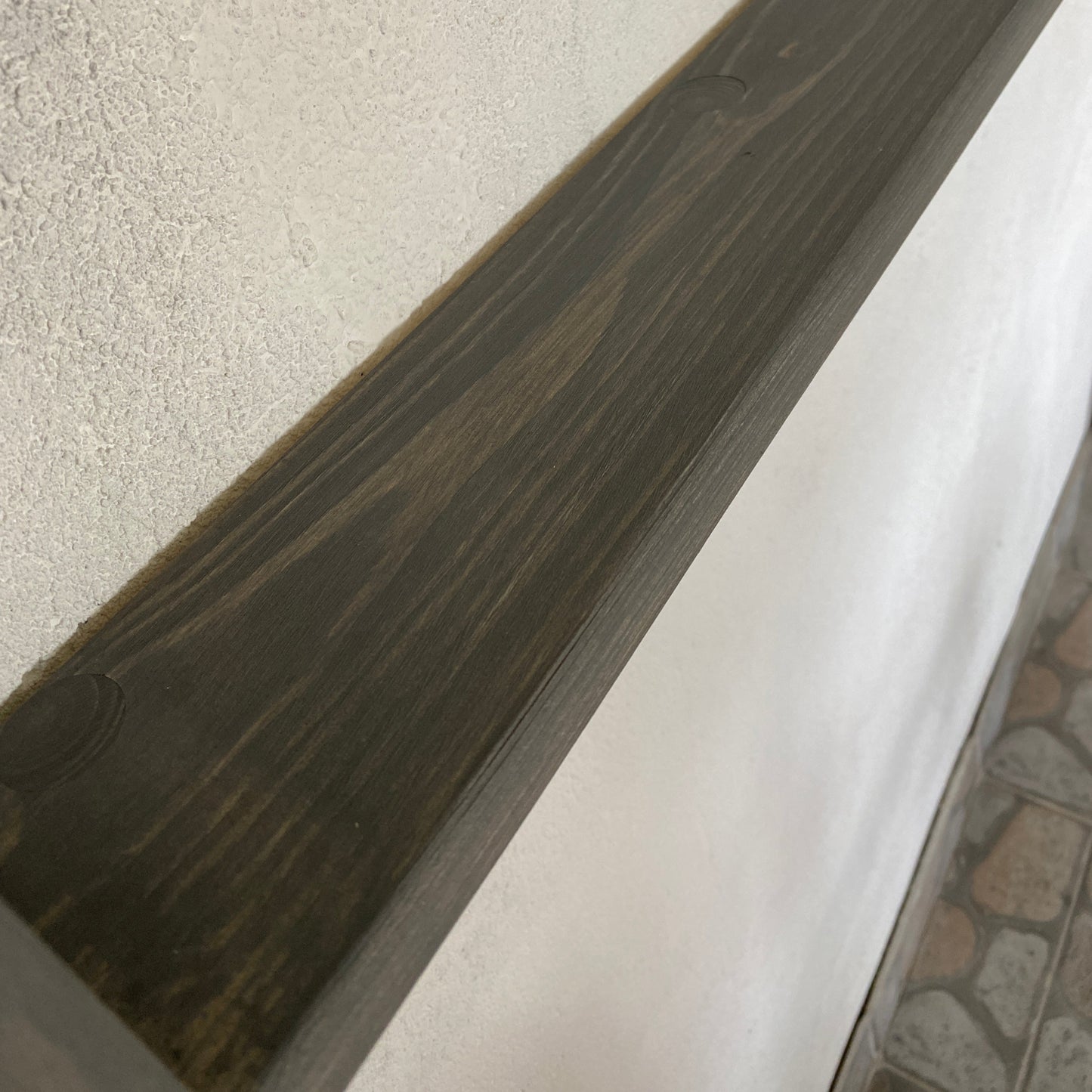 Wooden step with a white platform on a concrete surface