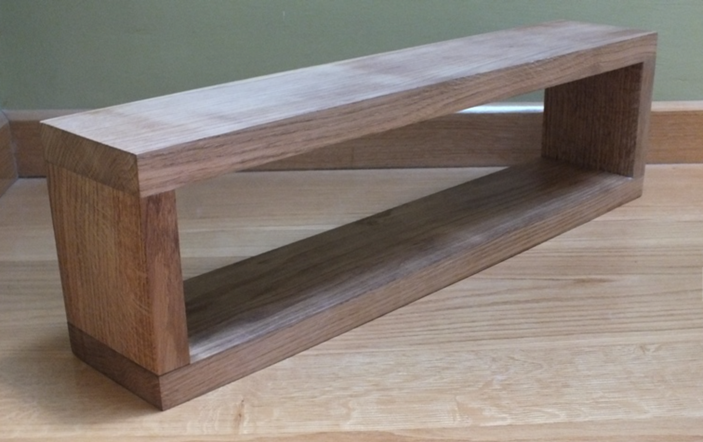 Wooden shelf on a wooden surface with a plain background