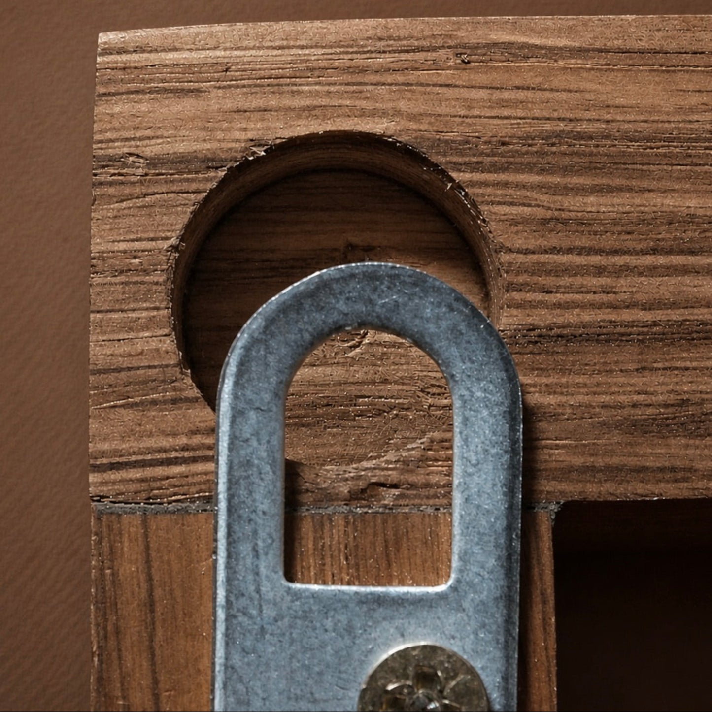 Metal bracket fitting into a wooden frame
