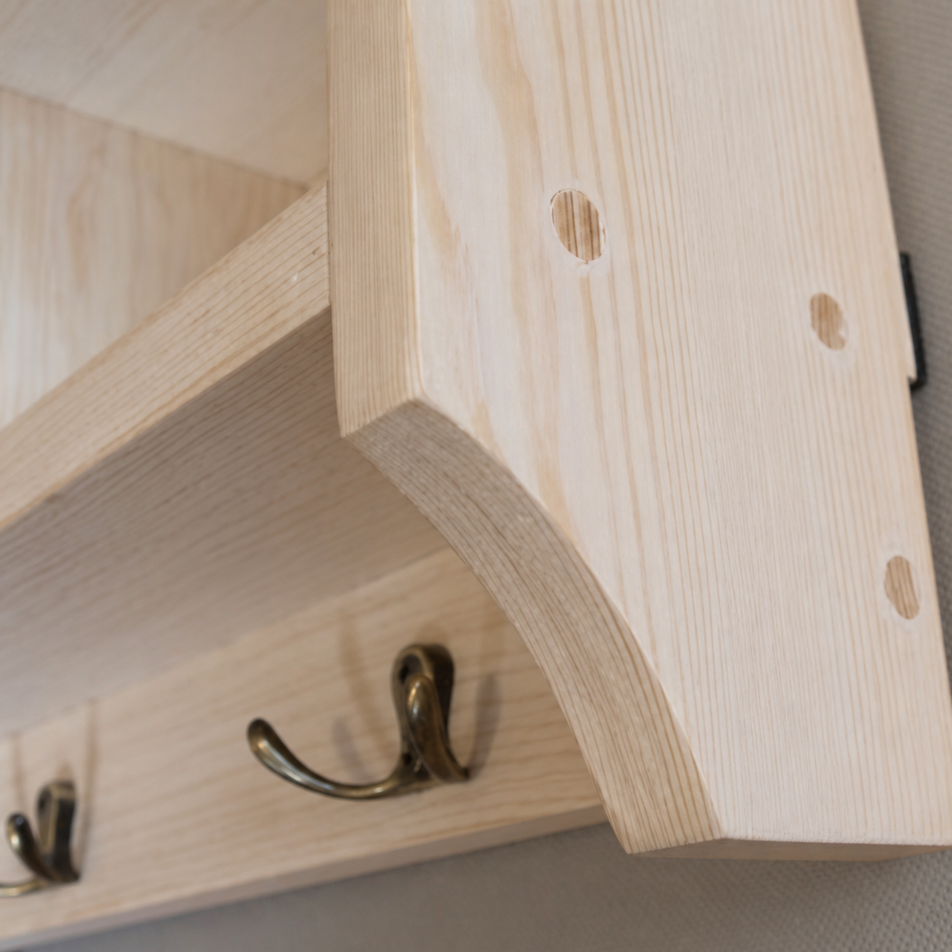 Wooden shelf with hooks on a neutral background