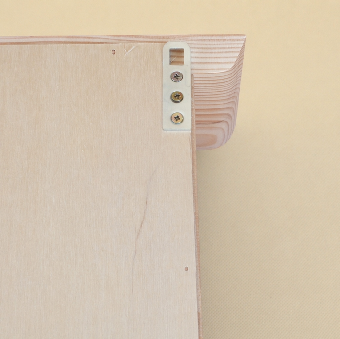 Close-up of a wooden shelf with a beige background