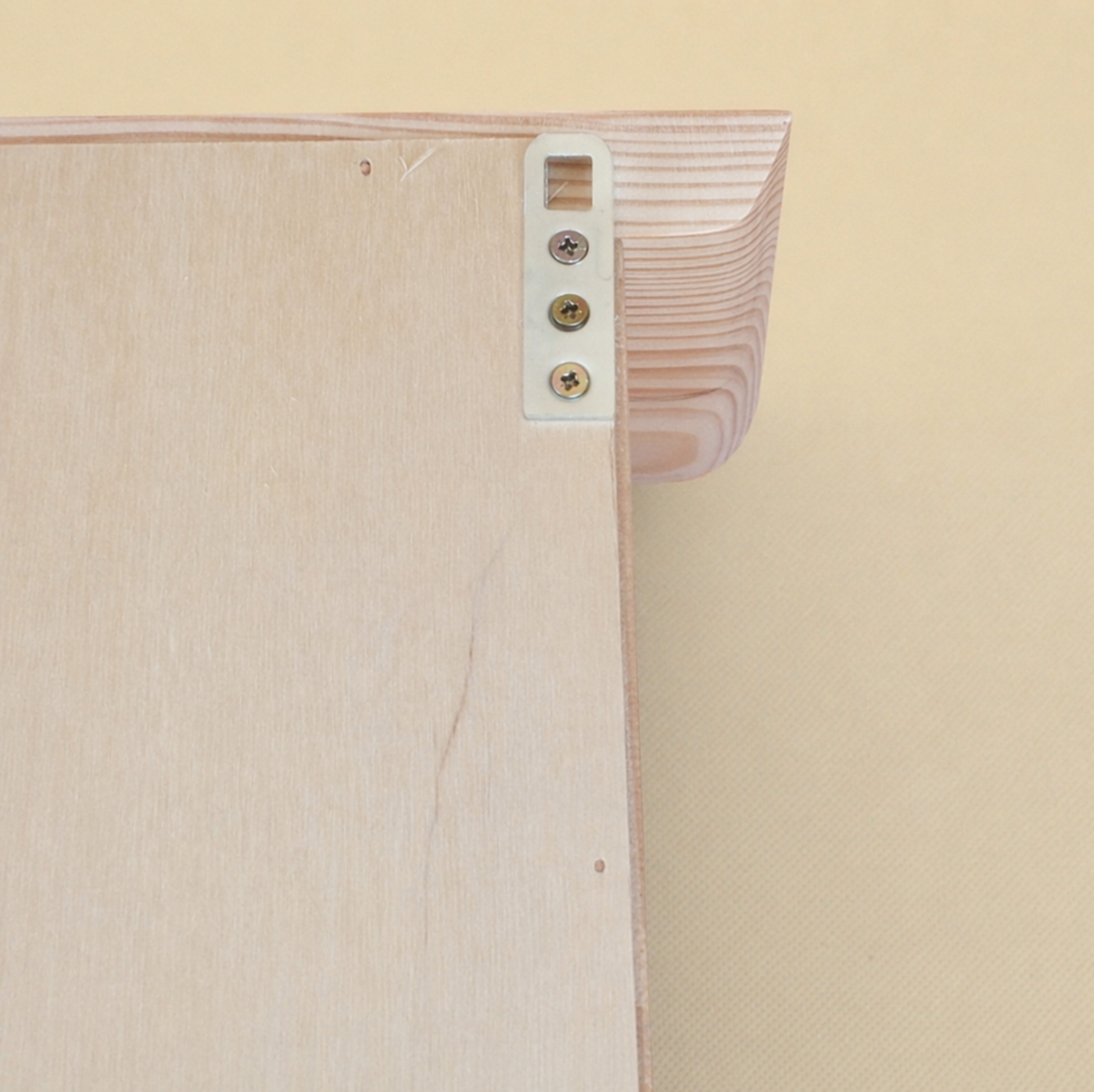 Close-up of a wooden shelf with a beige background