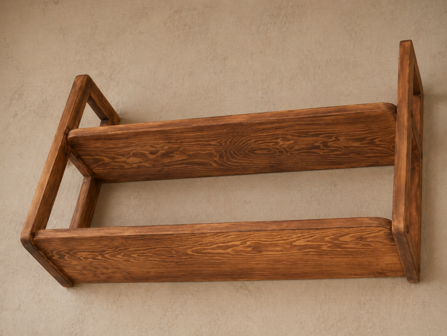 Wooden shelf against a beige wall