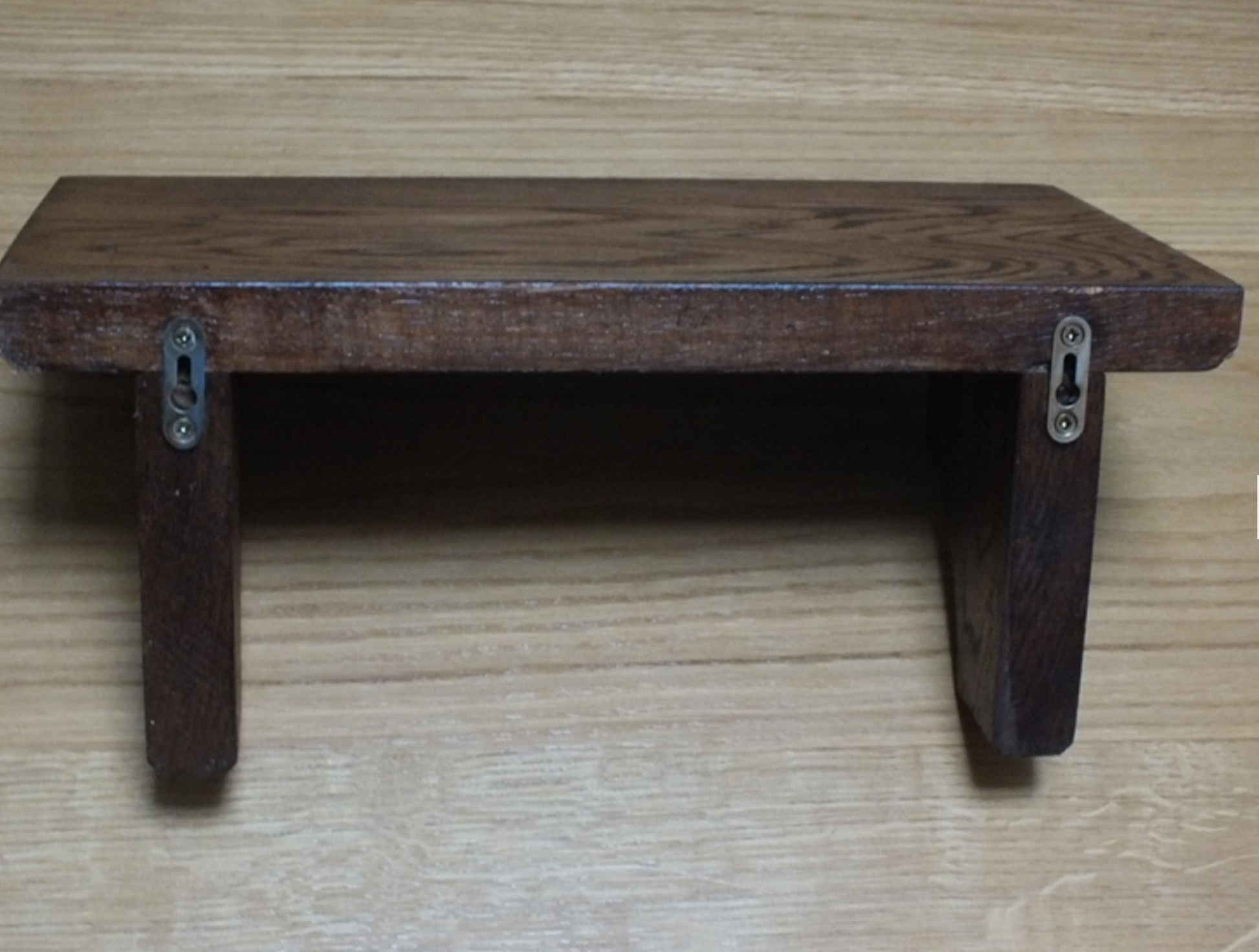 Wooden step stool on a wooden floor