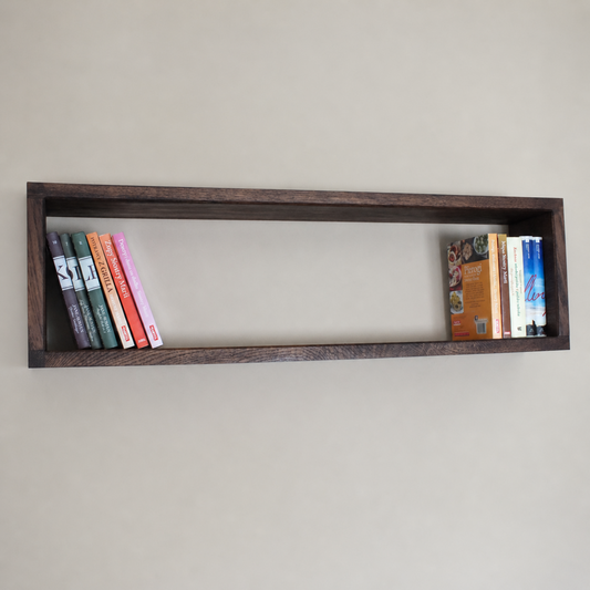 Wooden shelf with books on a plain wall