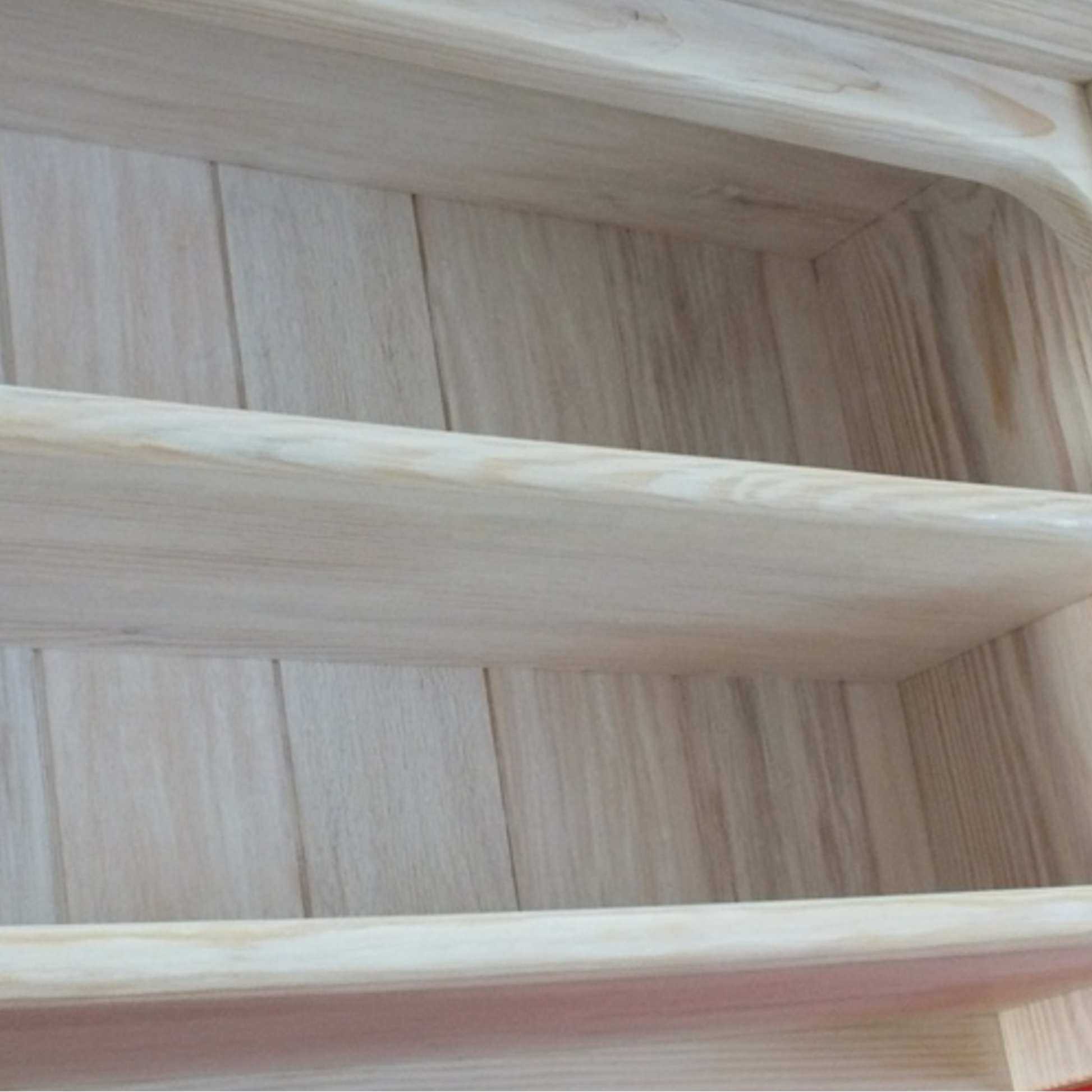 Wooden shelf with a red background