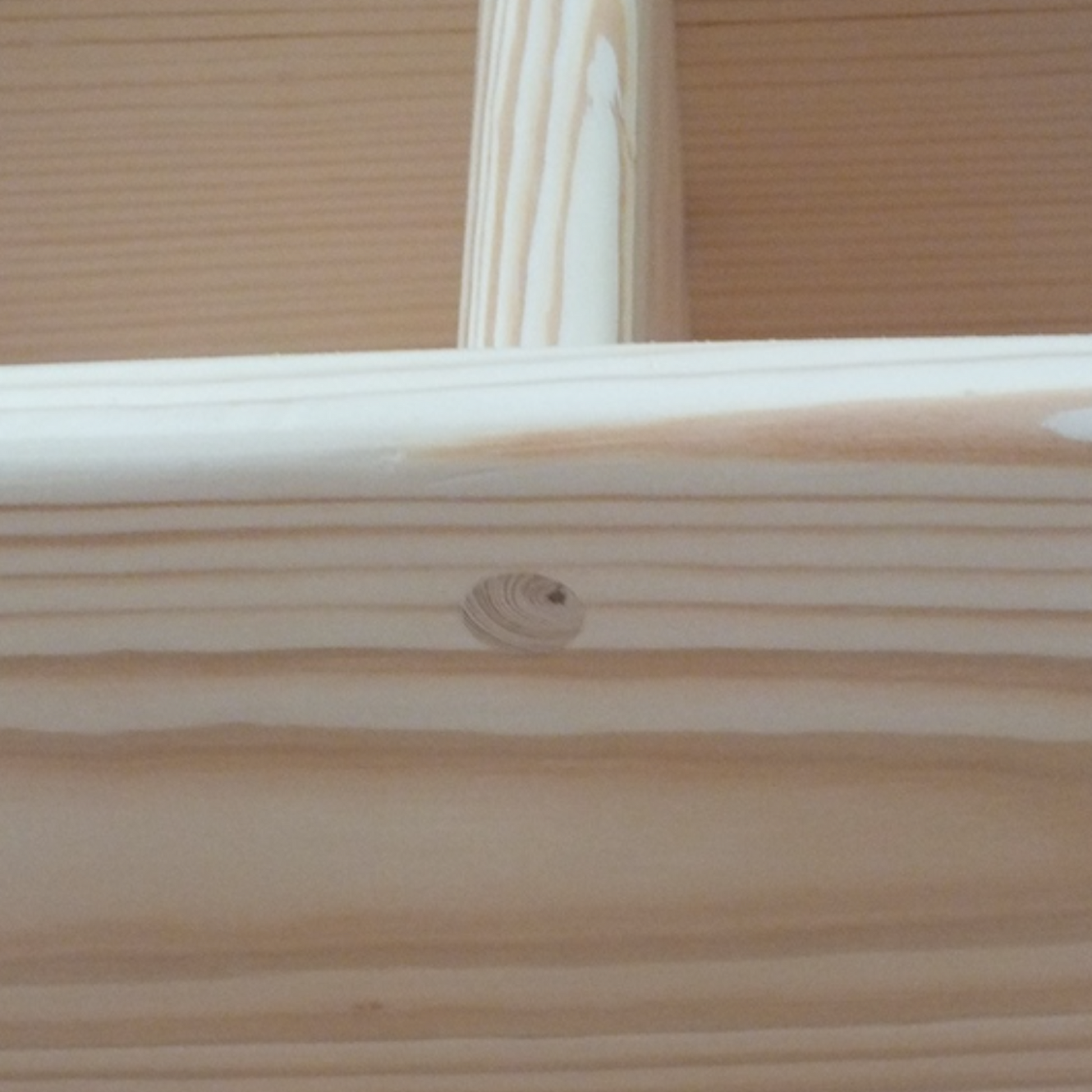 Close-up of a wooden frame with a visible grain pattern.