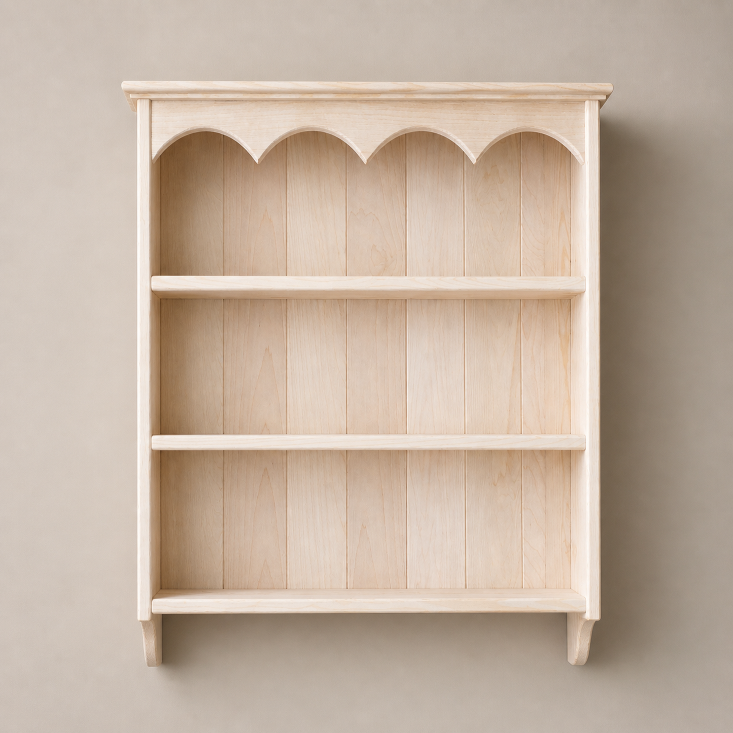 Wooden bookshelf with decorative top against a beige wall
