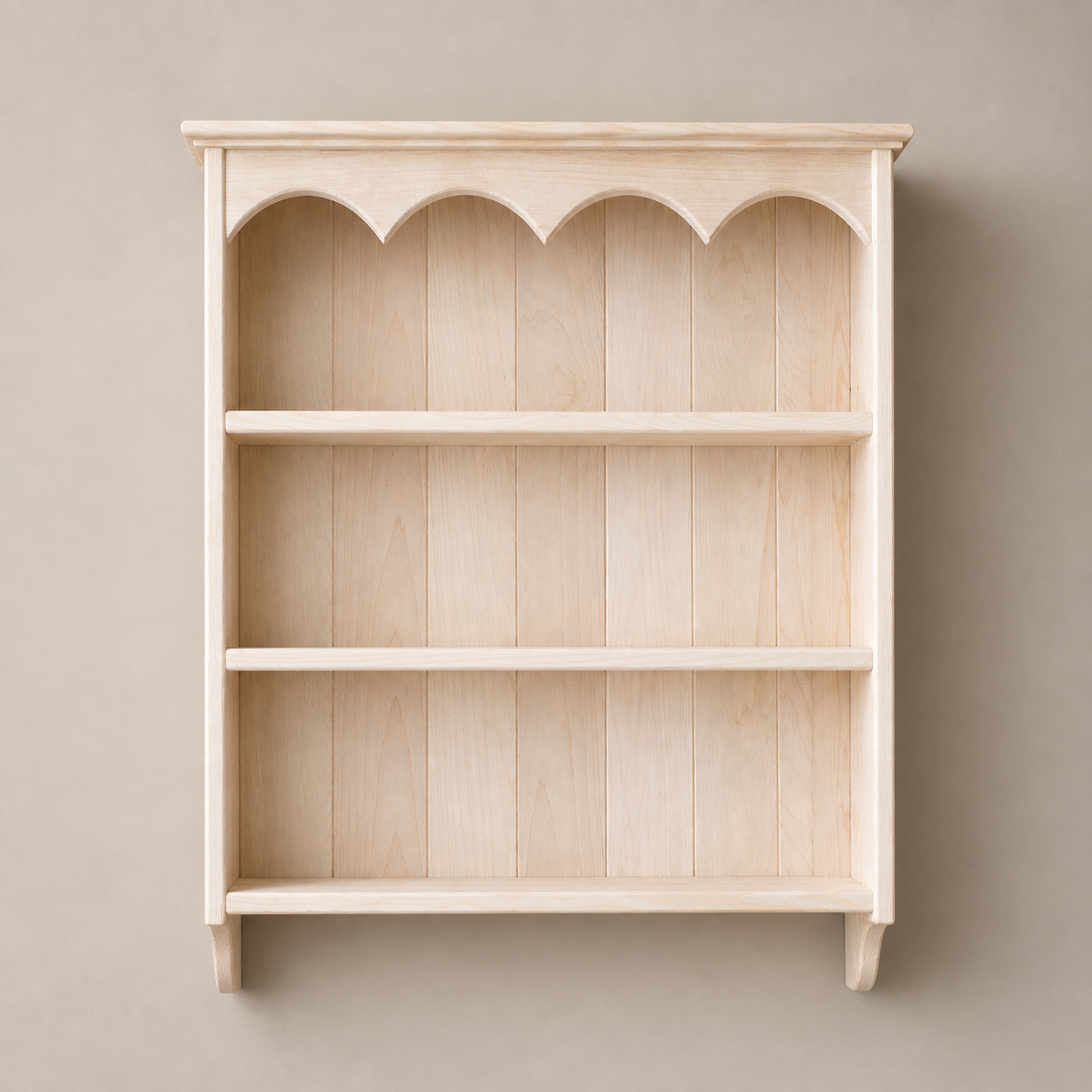 Wooden bookshelf with decorative top against a beige wall