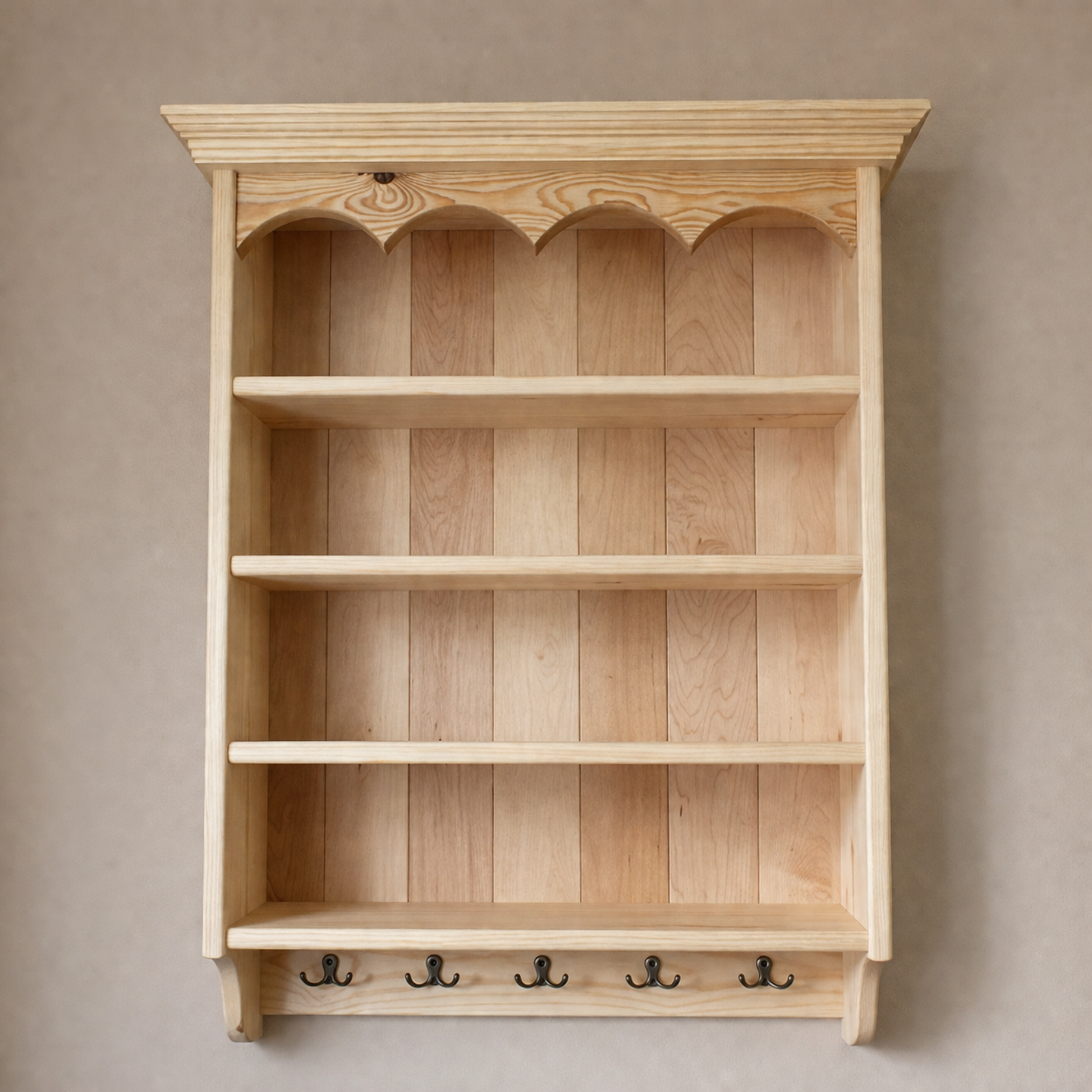 Wooden wall shelf with decorative top against a beige wall